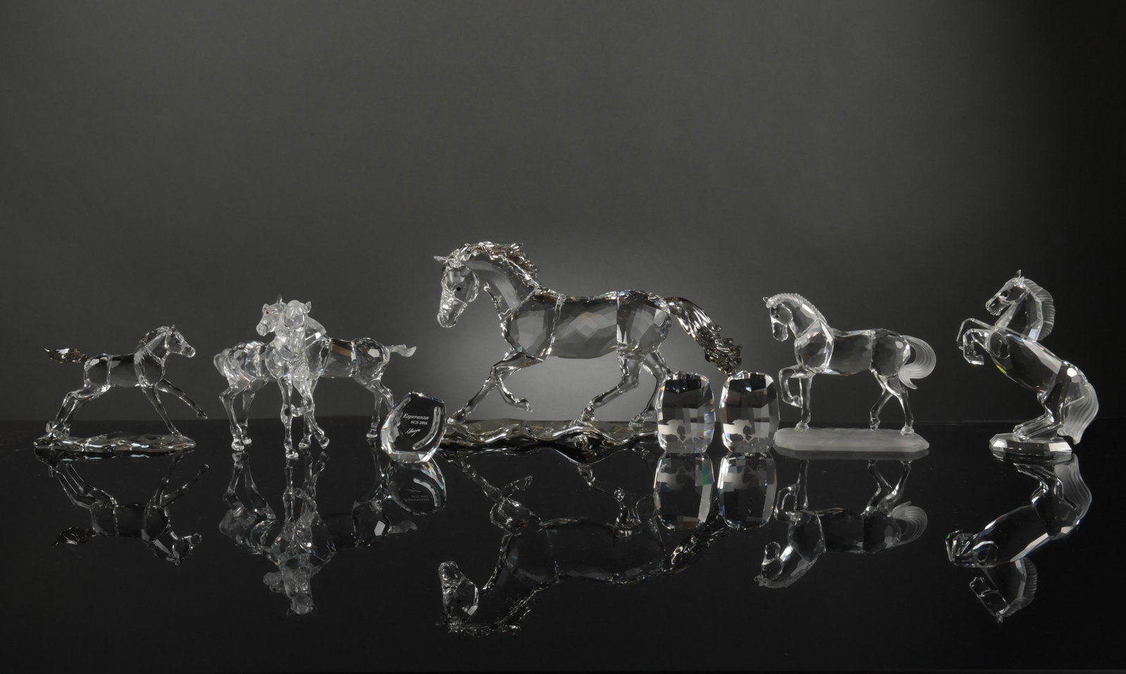 7 Boxed Swarovski Crystal Horses inc. SCS: Swarovski (Austrian, founded 1895) crystal. A group of 7 horse figurines. Includes: SCS 2014 Horse Esperanza with a plaque signed by Anton Hirzinger; A pair of foals; a rearing stallion; a stallion; a