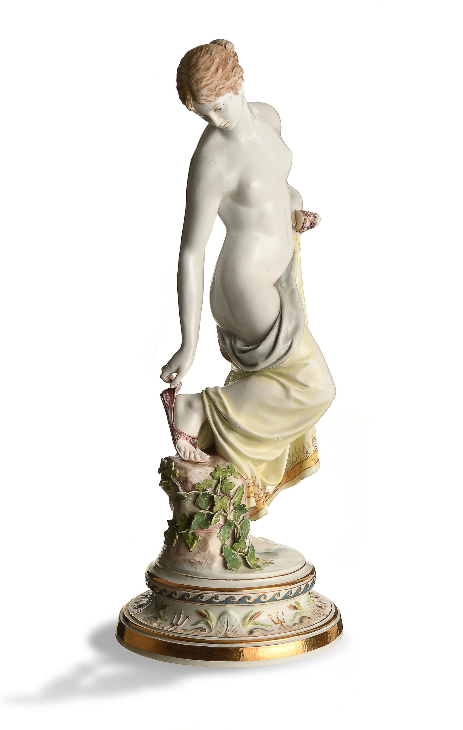 Meissen, After the Bath, Model M193: Meissen (German, founded 1710) porcelain. Designed by Robert Ockelmann, featuring a woman putting on her sandals. It is stamped with the Meissen mark, model number, '98,' and '29' on the base. Dimensi