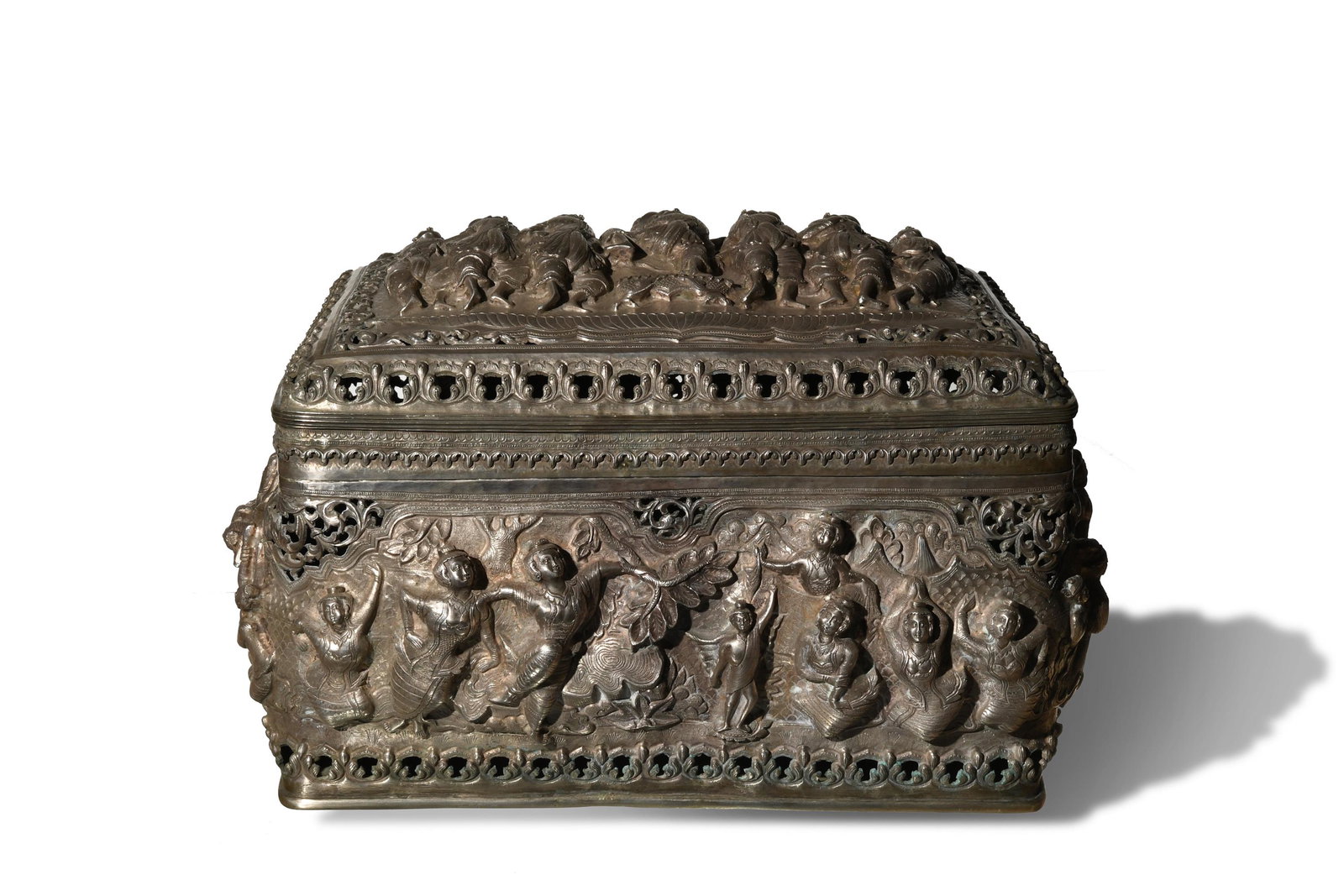 Large Burmese or Thai Silver Repousse Box: A large, deeply repousse silver box with scenes of dancing figures on all sides and the lid. Dimensions: 9 3/4 inches all X 15 1/2 inches wide; 24.8 cm tall X 39.4 cm wide. Weight: 3700 grams. 119 ozt