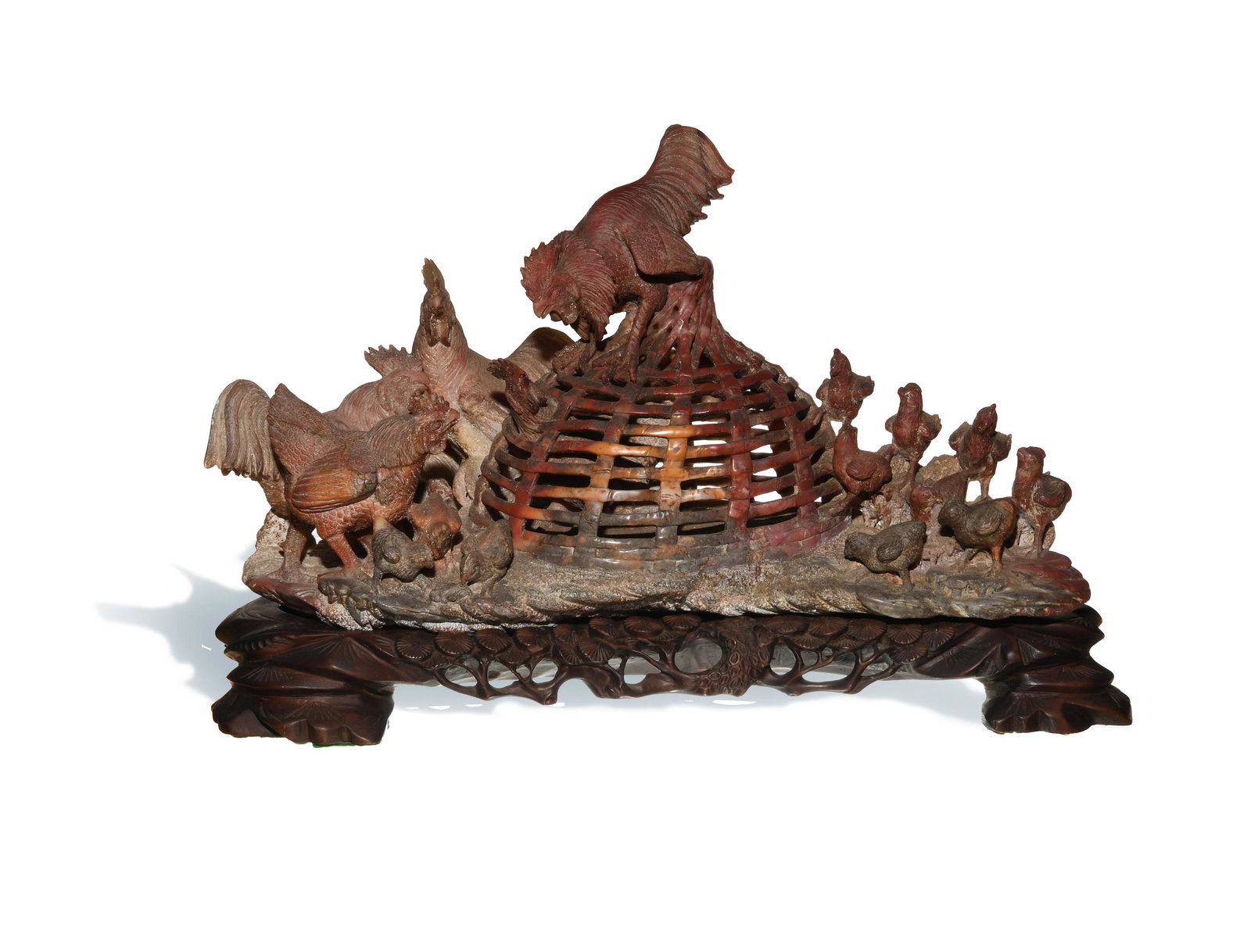 Chinese Soapstone: A soapstone carving of 2 roosters fighting while being watched by hens with chicks, dating from the 20th century. The sculpture comes with a wooden stand. Dimensions: 9 1/2 inches tall X 16 1/2 inches