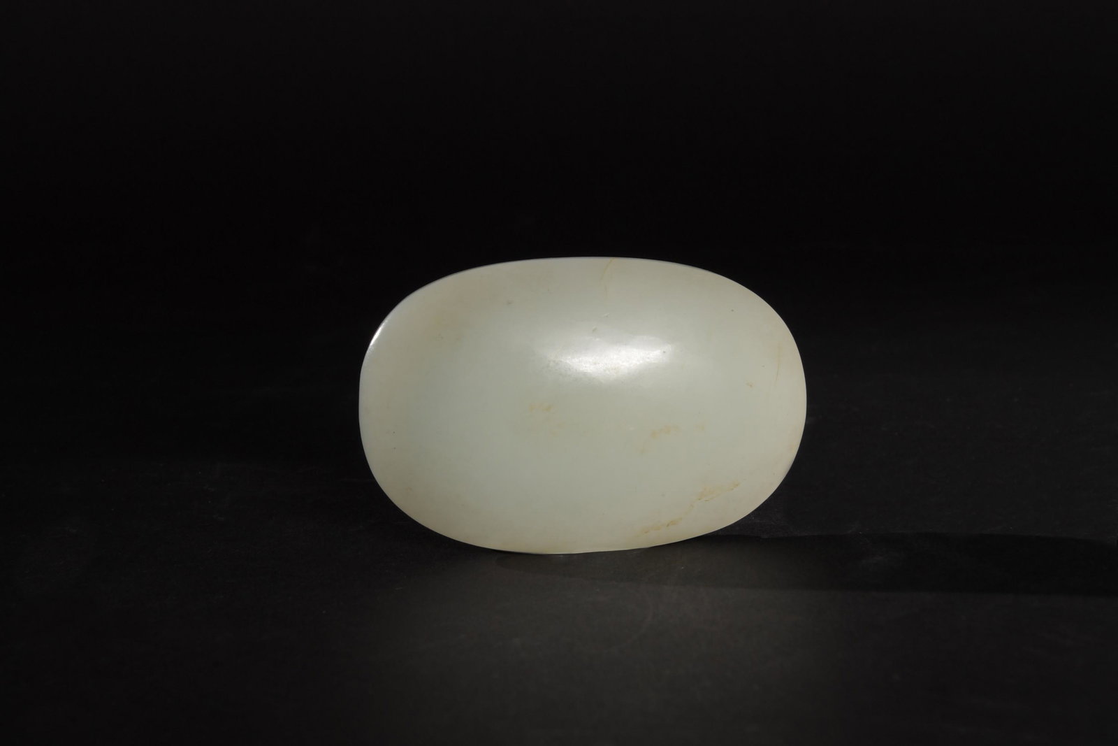 Chinese White Jade Ruyi Plaque, 18th Century: A smoothly polished Chinese white jade ruyi plaque dating from the 18th century. Dimensions: 2 inches tall X 3 1/8 inches wide; 5.1 cm tall X 7.9 cm wide. All measurements are approximate. Condition: 