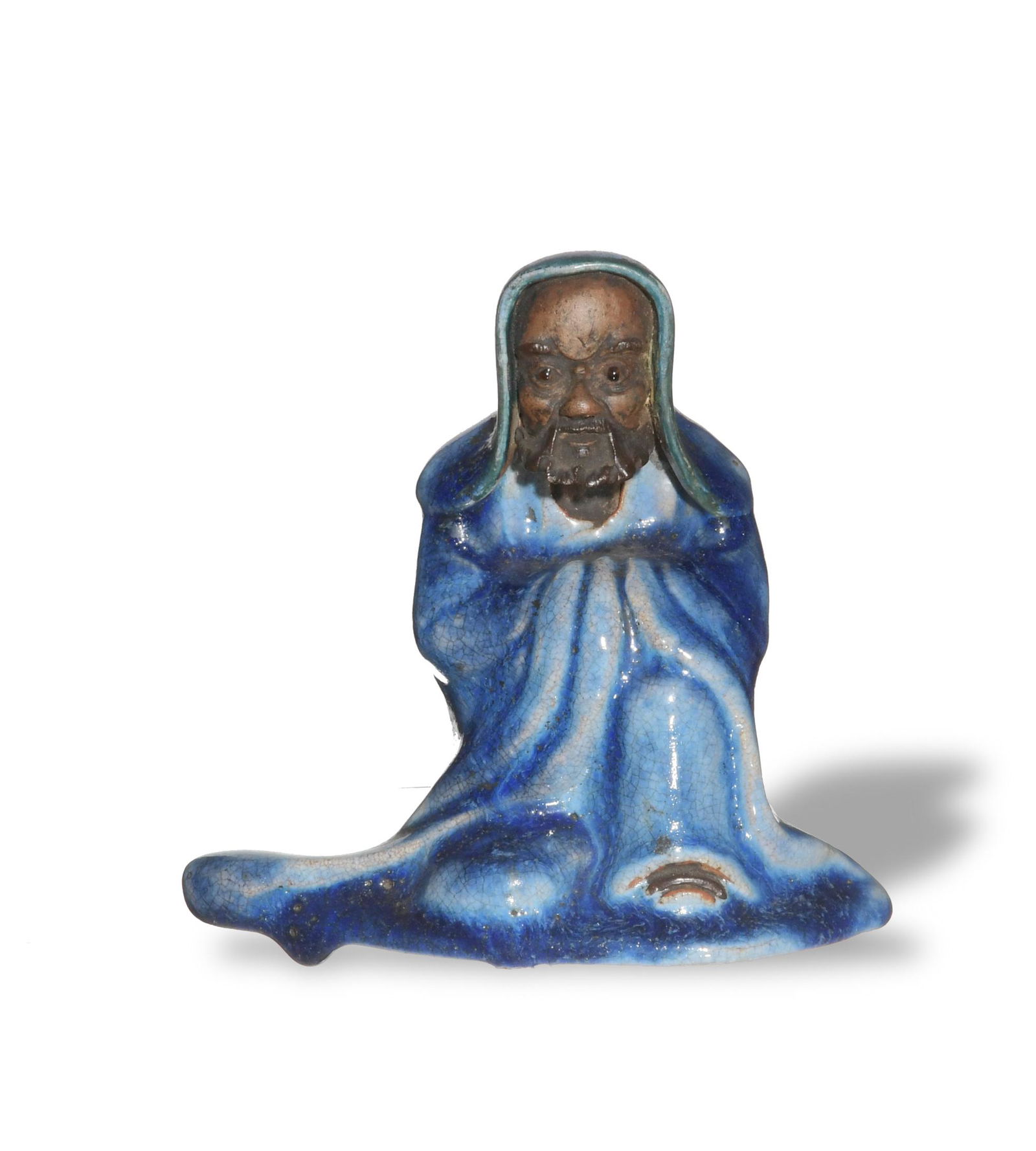 Shiwan Damo Statue with Blue Glaze, 19th Century: A Shiwan kiln statue of Damo dating from the 19th century. Damo is portrayed seated and in blue glazed robes. Dimensions: 5 inches tall X 5 3/8 inches wide; 12.7 cm tall X 13.7 cm wide. All measuremen