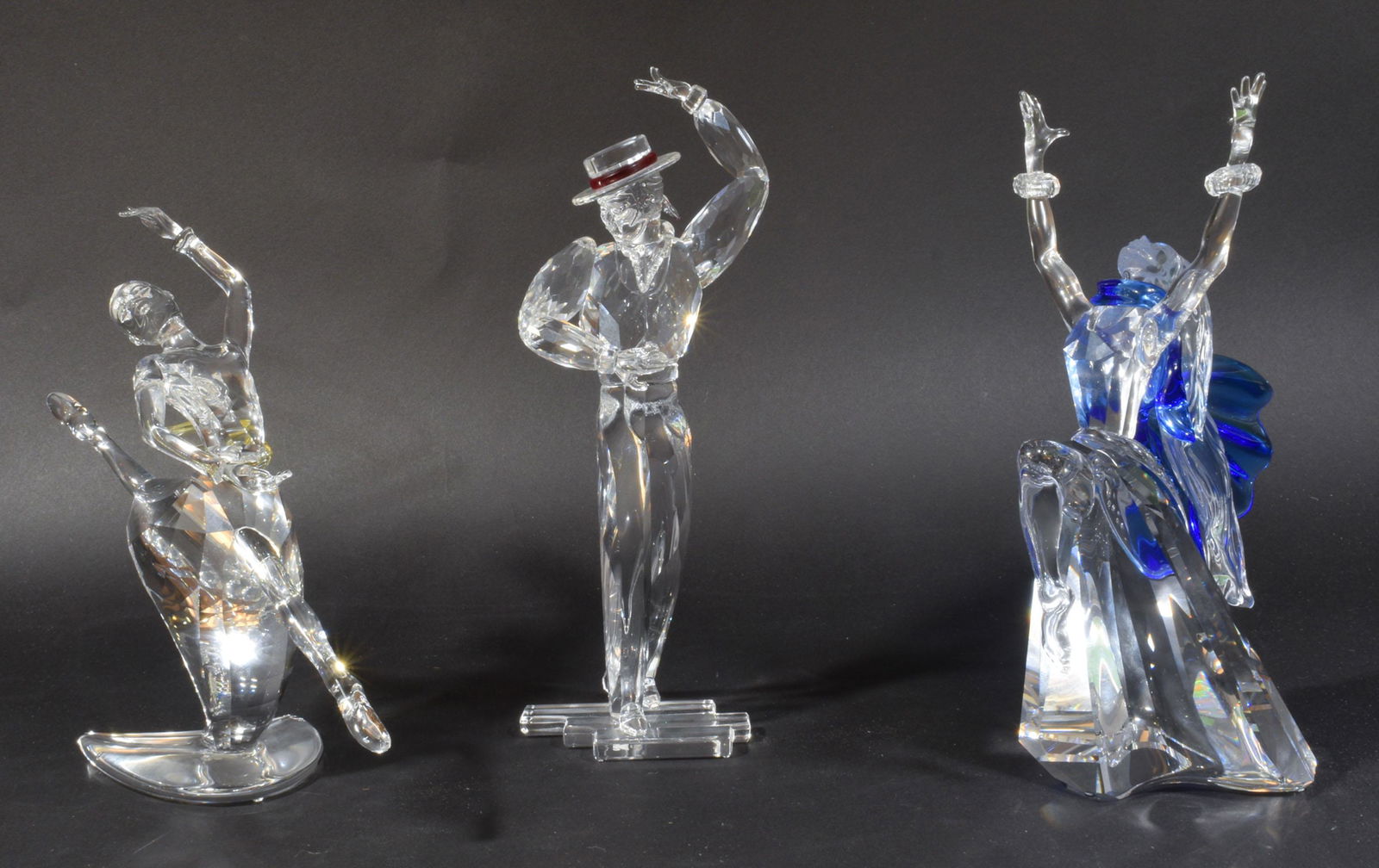 3 Boxed Swarovski Magic of the Dance, 2002-2004: Swarovski (Austrian, founded 1895) crystal. A group of the Magic of Dance pieces including: the 2002 Isidora, 2003 Antonio and 2004 Anna. All of the figurines are portrayed mid dance and come in the o