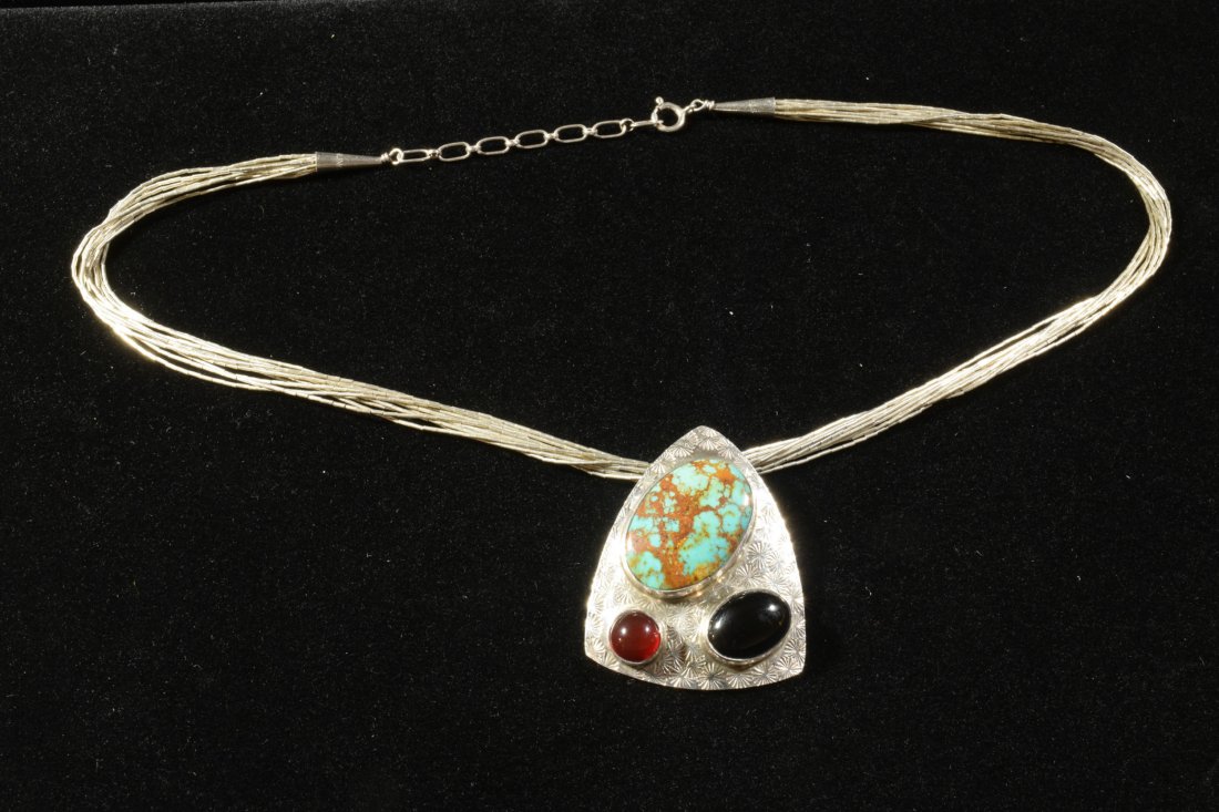 Everett and Mary Teller, Navajo Sterling Necklace: Everett and Mary Teller (Navajo, 20th century), sterling silver and precious stones. Multi-strand sterling bead necklace with tooled pendant set with turquoise, onyx and carnelian. Dimensions: 18 inch