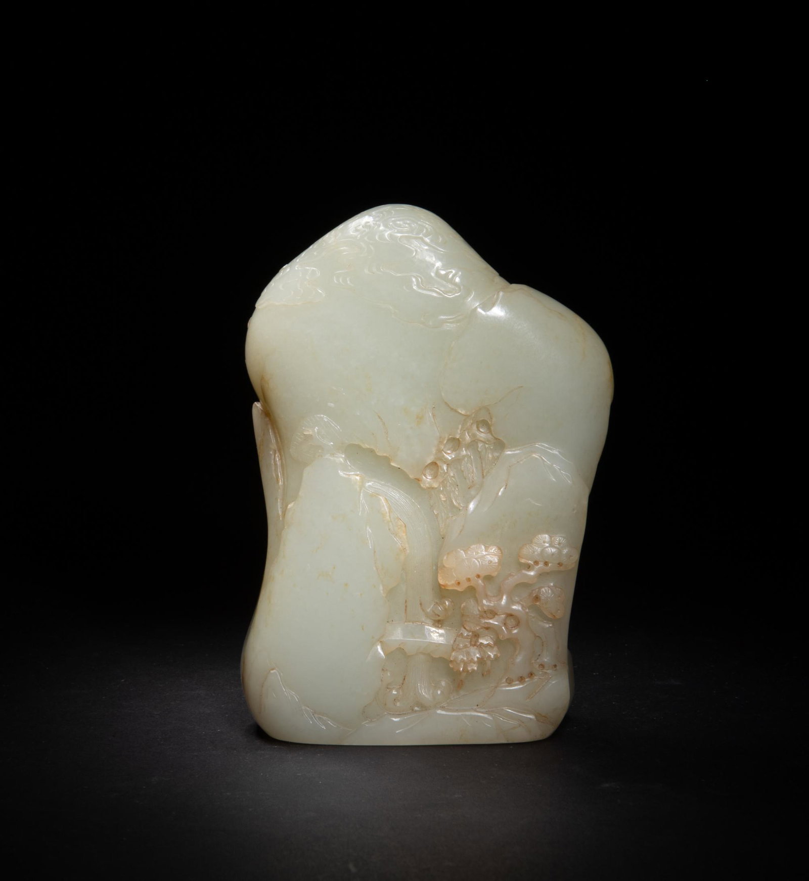 Chinese Jade Boulder with Damo, 18th Century: A Hetian white jade boulder dating to the 18th century. The boulder is decorated with Luohan Damo riding on the river through a watery cave, and the reverse features a bridge in front of a waterfall. 