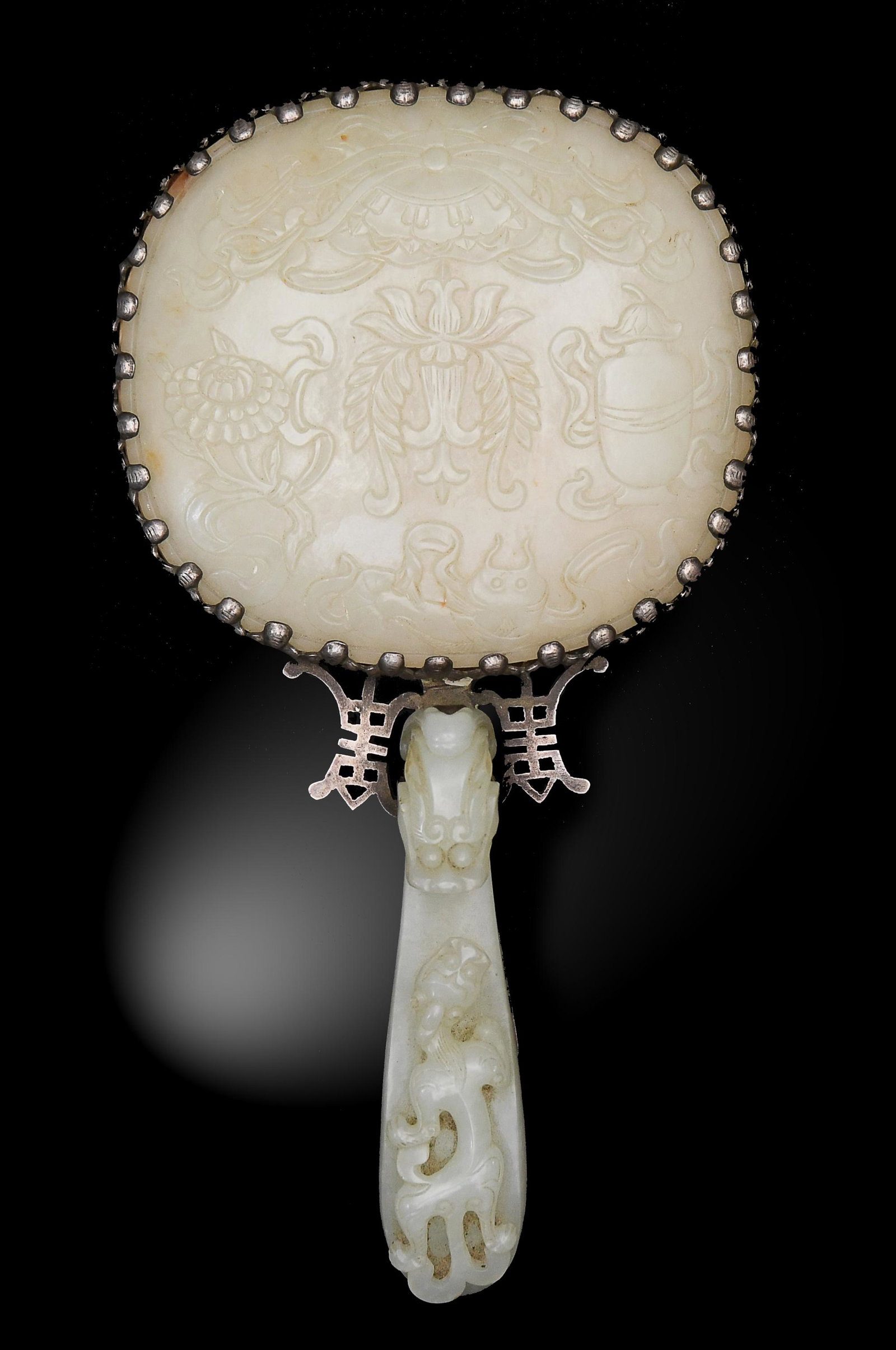 Chinese Hand Mirror with White Jade Insets, 18th: A Chinese hand mirror dating from the 18th century. The mirror features an inlayed jade plaque and a jade dragon-hook handle. The dragon hook shows a carving of a Chilong and the plaque is carved in l