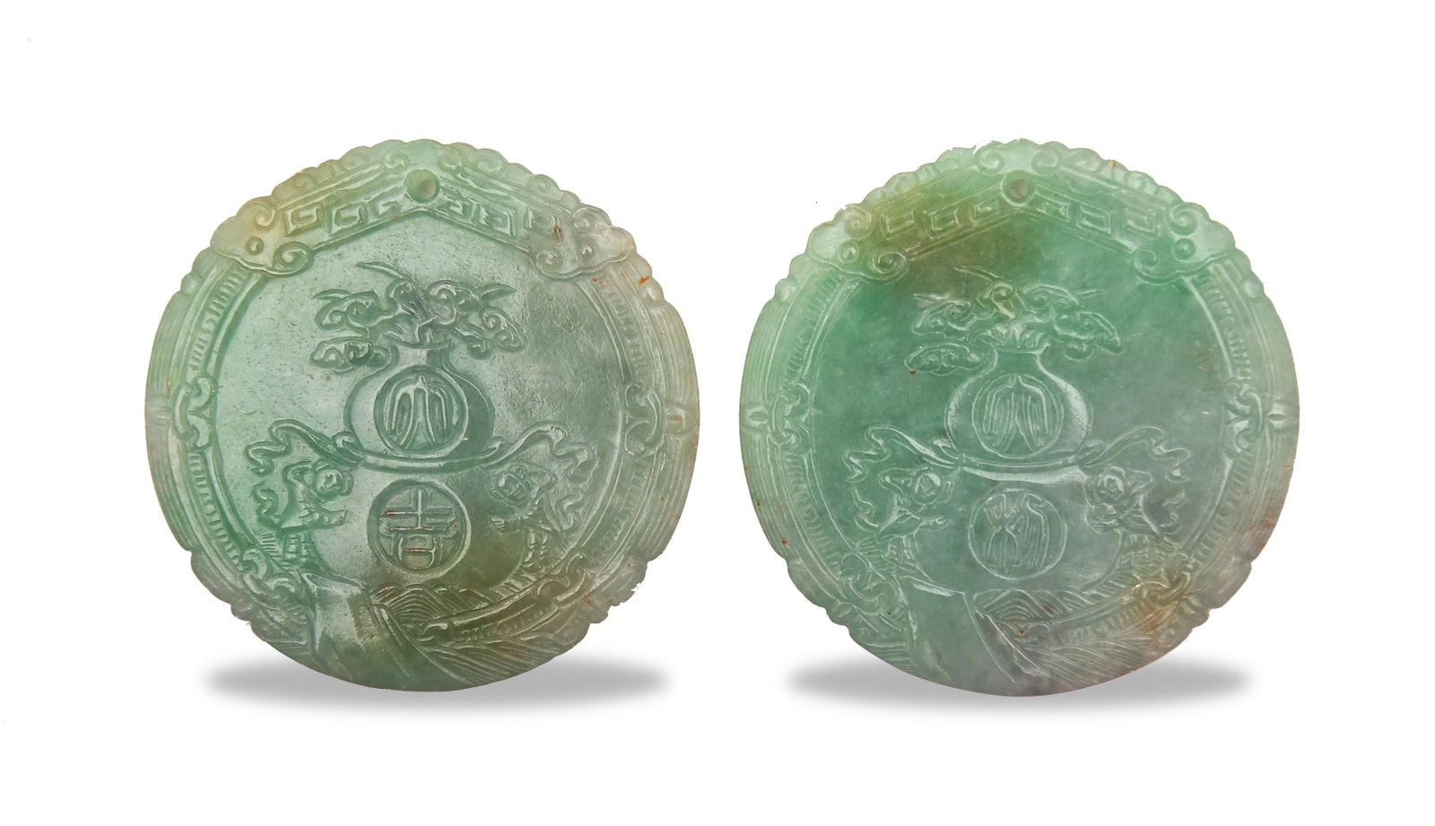 Pair of Jadeite Plaques, Late Qing: A pair of round Chinese jadeite plaques dating to the late Qing dynasty. One side of the plaques is decorated with hulu vases and Da Jie and Da Li, respectively. The other side is decorated with a fou