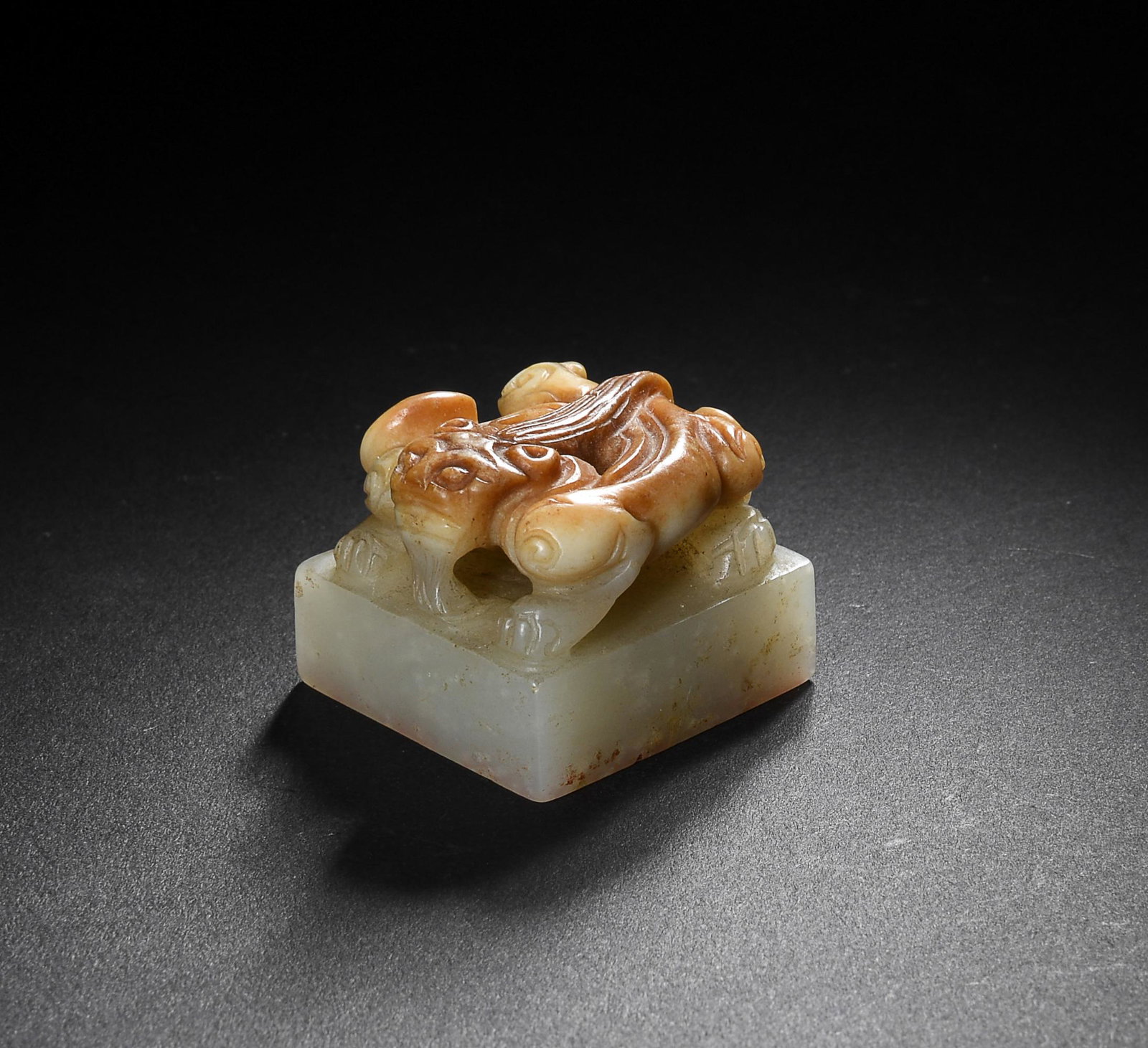 Chinese Jade Seal with Chilong Finial, Ming: A Chinese jade seal dating from the Ming dynasty. The top has a carving of a chilong, while the bottom has "Qi Wei Gong Ming Shi Du Shu" carved into it. Dimensions are: 1 inch tall X 1 1/4 inches wide