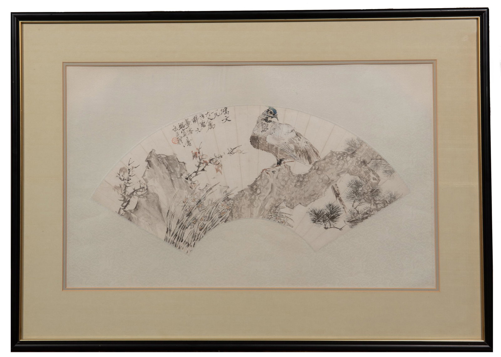 Chinese Fan Painting of Eagle by Wang Li: A Chinese watercolor and ink painting on a paper fan by Wang Li. The painting depicts a bird on a pine branch with narcissus flowers. It is mounted on a silk backing, matted, and framed. Dimensions ar