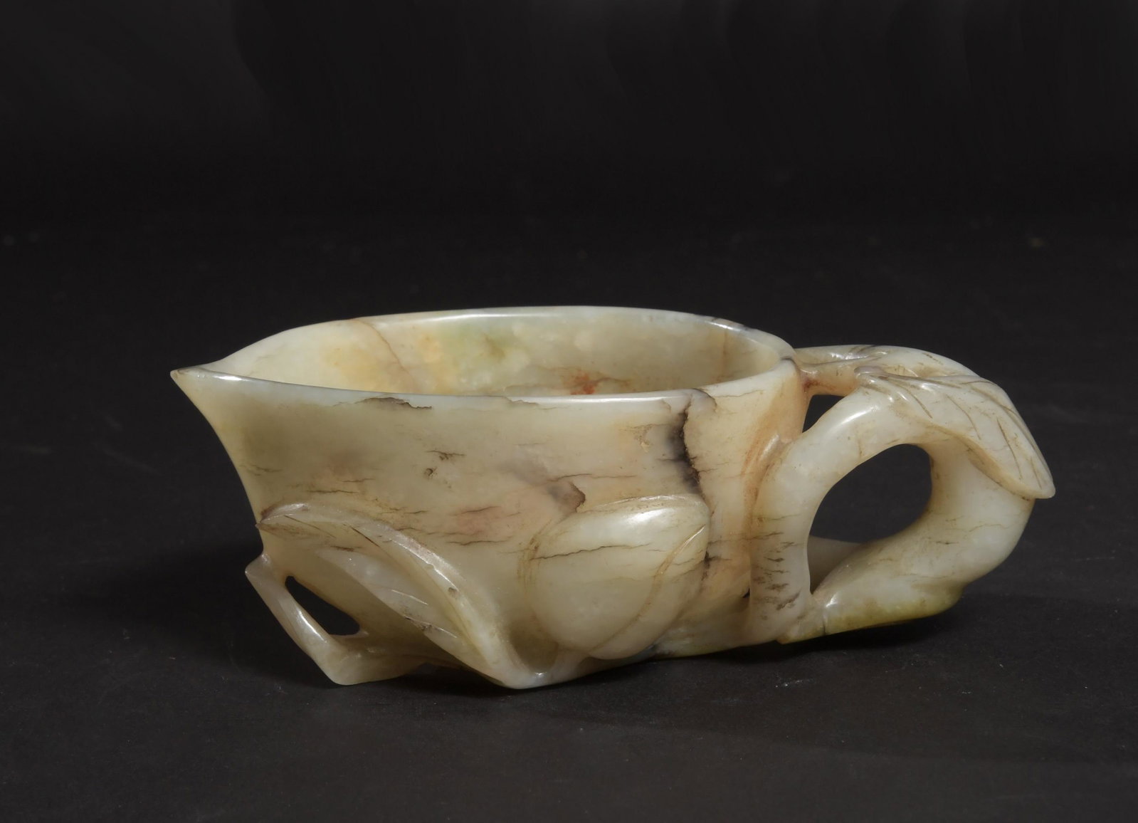 Chinese Jade Carved Peach Cup, Ming Dynasty: A Chinese jade carved peach-shaped libation cup dating from the Ming dynasty. Dimensions: 1 3/4 inches tall X 5 inches wide; 4.4 cm X 12.7 cm. All measurements are approximate. Condition: It is in goo