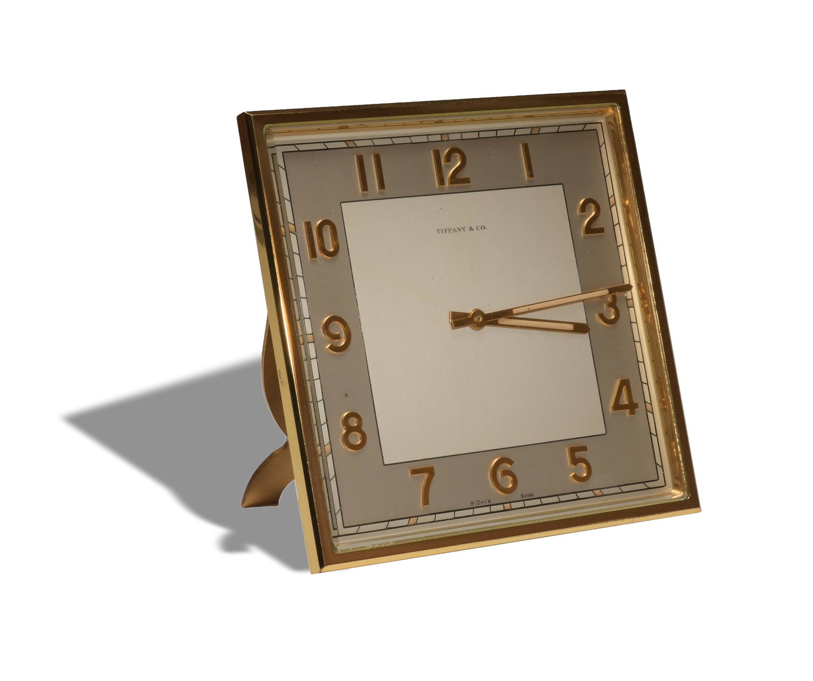 Tiffany and Co., Cased 8 Day Desk Clock: Tiffany and Co. (American, founded 1837). A gilt 8-day desk clock in fitted case. The clock has a Swiss movement and multiple marking on the reverse. Dimensions: 5 5/8 inches tall X 5 5/8 inches wide;