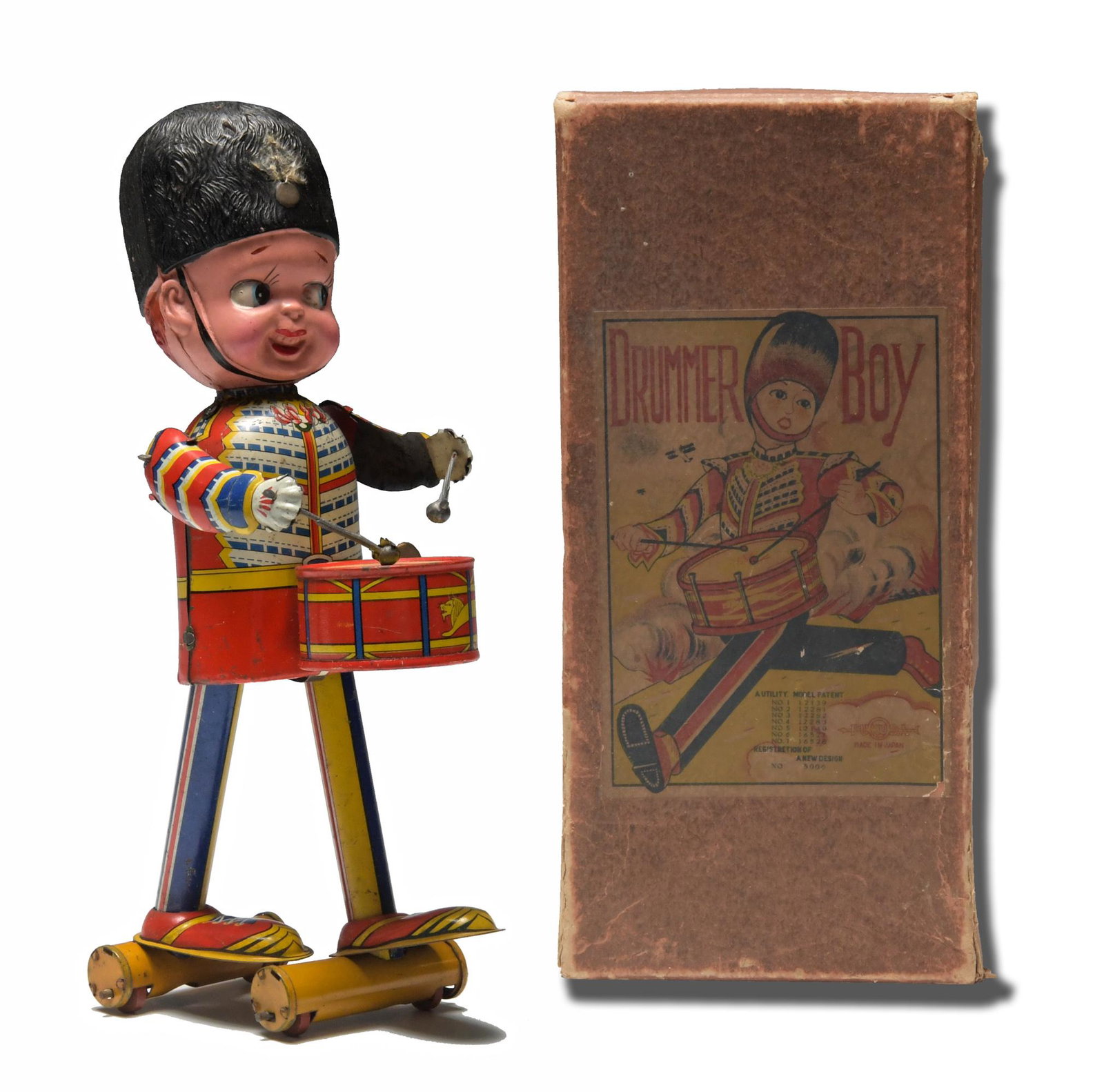 Boxed Prewar Japan Drummer Boy by Fukuda: A circa 1935 tin windup toy featuring a drummer boy with a celluloid head, comes with a key. Dimensions: 9 1/4 inches tall X 5 inches wide; 23.5 cm tall X 12.7 cm wide. Weight: 130.1 grams. All measur