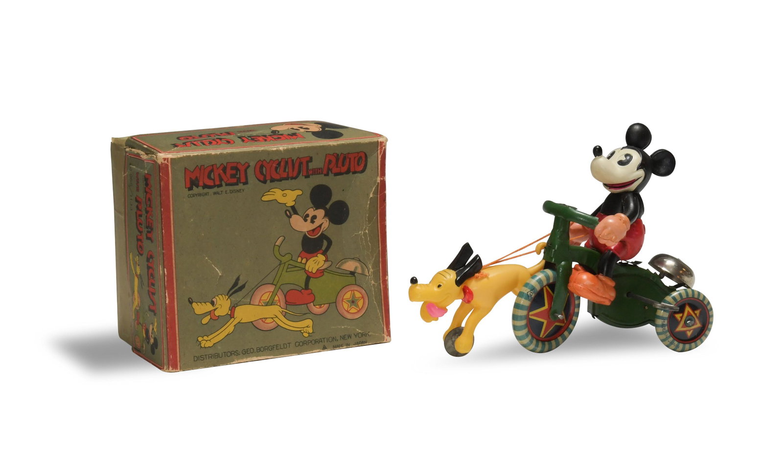 Boxed Mickey Cyclist with Pluto Circa 1932: A scarce tin and celluloid Mickey Mouse on tricycle with celluloid Pluto. The tricycle is marked 'made in Japan.' It comes with the original box. The box features marks from Geo. Borgfeldt corporation