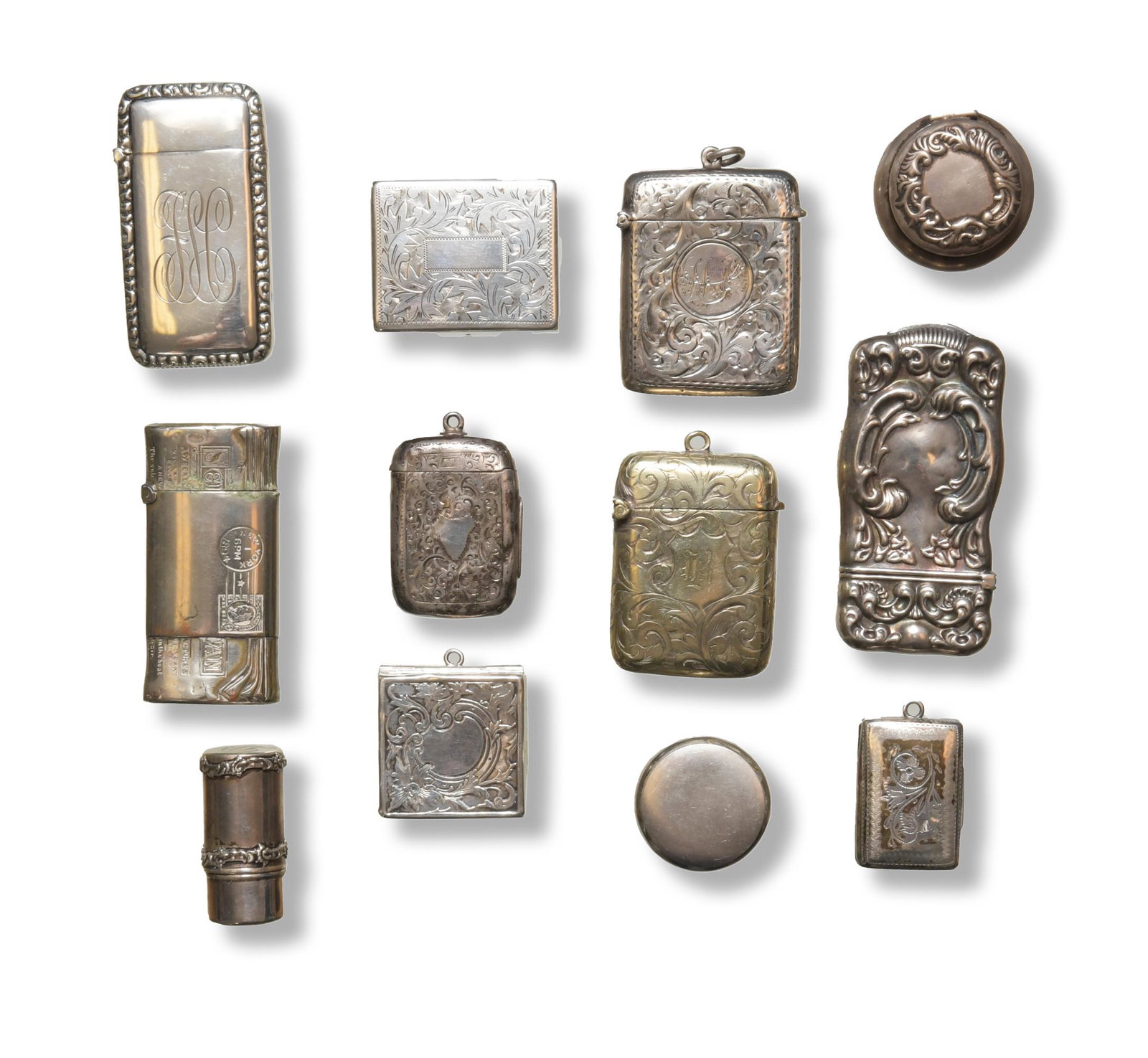 12 Sterling Silver Vestas, Pillboxes, Stamp Case: A group of 12 sterling silver vestas, pill boxes and stamp cases dating from the Victorian and Edwardian period. Includes an unusual figural example as a bundle of letters postmarked 1894. The boxes c