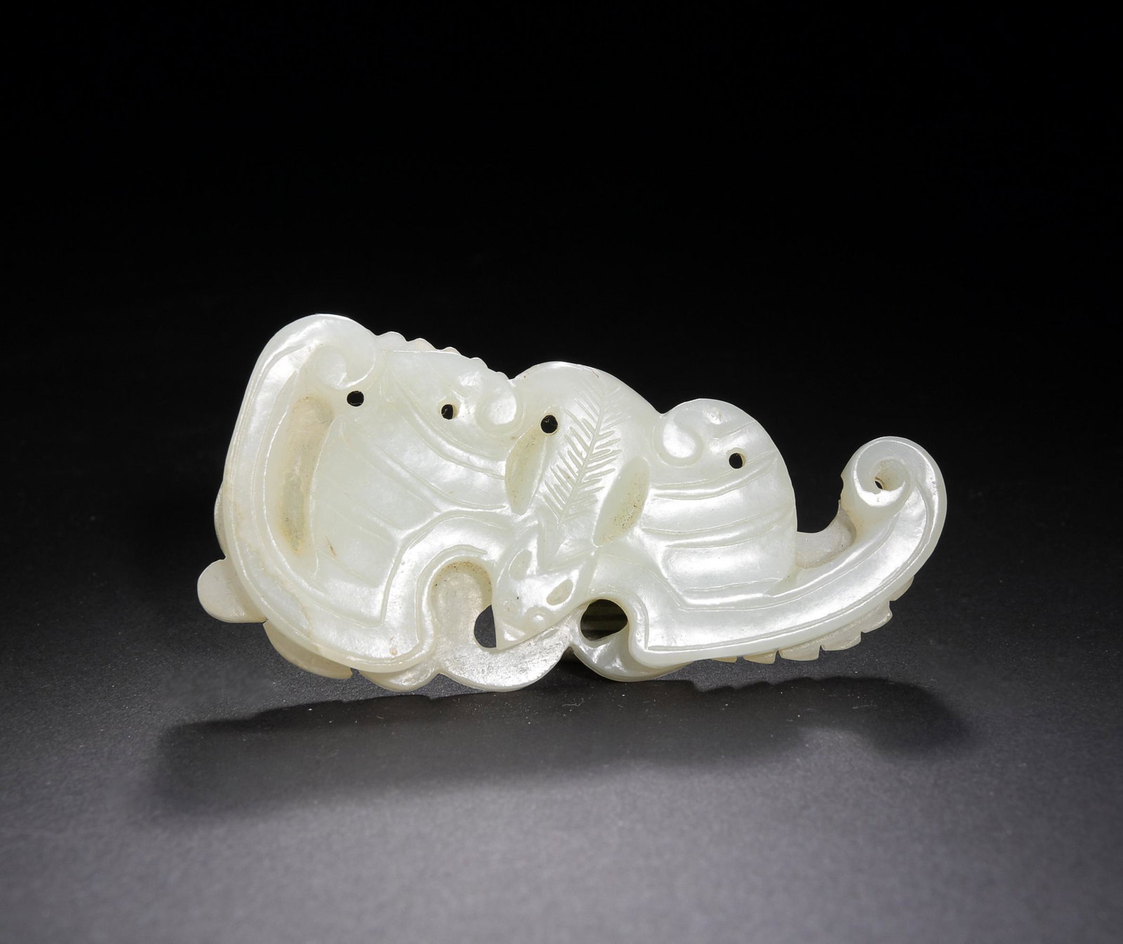 Chinese White Jade Plaque of Bat, 19th Century: A Chinese white jade carved plaque featuring a bat and flowers and dating from the 19th century. It was meant to support 5 additional pendants as a part of a larger jewelry set. Dimensions: 1 1/2 inch