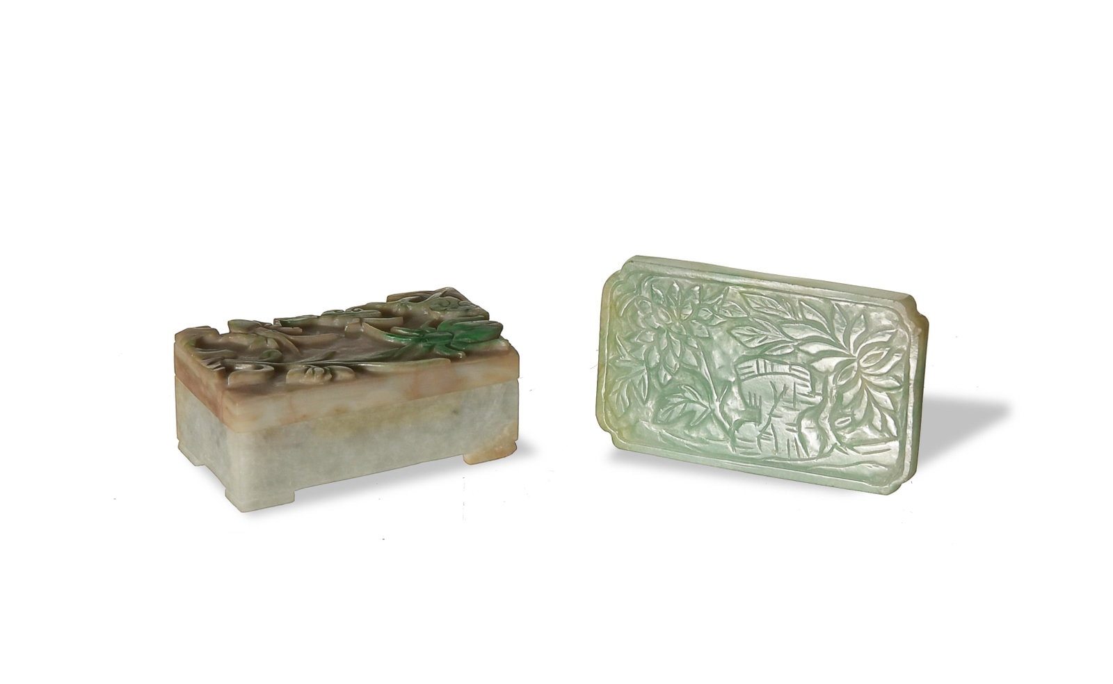 Chinese Carved Jadeite Buckle and Box, 19th Century: A group of 2 Chinese jadeite items dating from the 19th century. The buckle features a pair of flowers and a rock; the box features orchids, insects and lingzhi on the lid. Dimensions: buckle- 2 inche