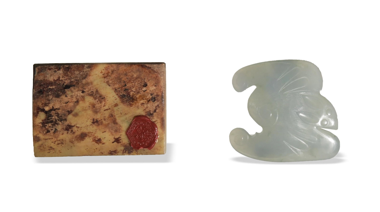 Two Chinese Jade Plaques, 18-19th Century: A group of two jade plaques dating from the 18th to the 19th century. One is a bat-form belt buckle; the other features a deer and a bat beneath a pine tree. Dimensions: 2 inches tall X 3 inches wide;