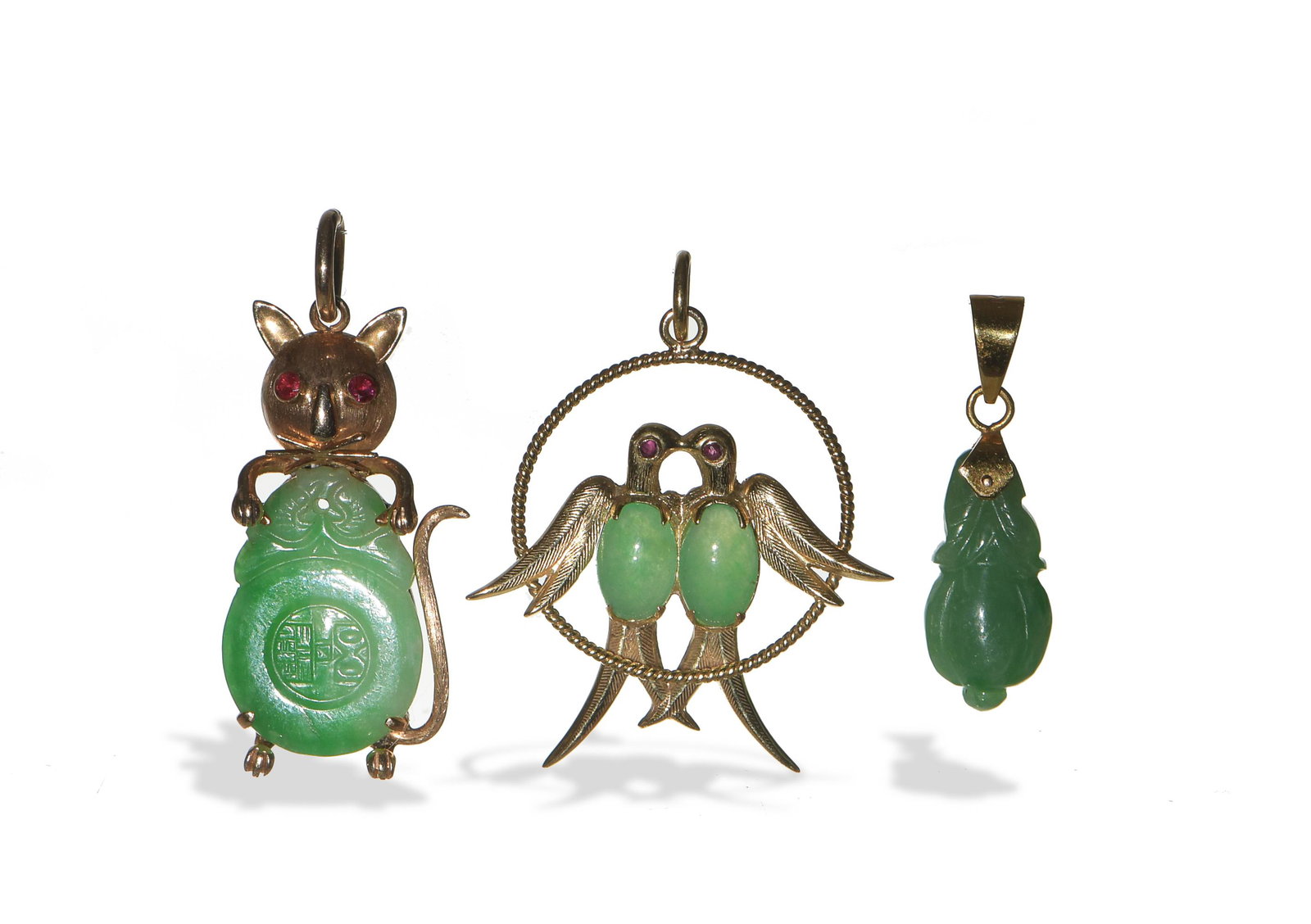 Group of 3 Chinese Jadeite Pendants, Republic: A group of three Chinese jadeite pendants dating from the Republic period. The group includes: a jadeite gourd with an unmarked clasp; a pendant featuring a pair of birds with ruby eyes and jadeite ca