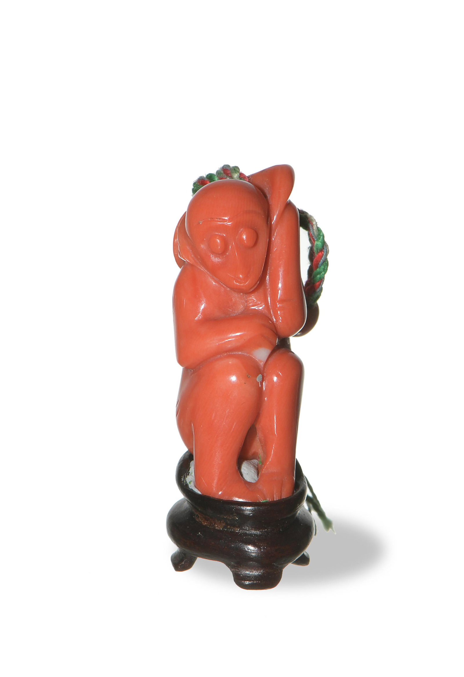 Chinese Coral Carving of a Monkey, 19th Century: A Chinese coral carving of a monkey dating from the 19th century. Dimensions: 1 3/8 inches tall X 1/2 inches wide, 3.5 cm tall X 1.3 cm wide. Weight: 13.6 grams. All measurements are approximate. Cond