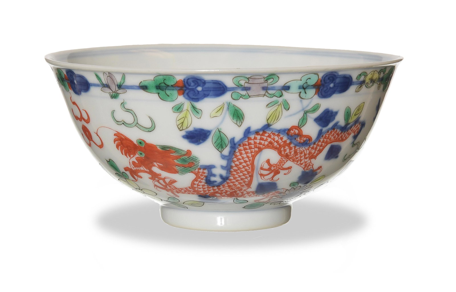 Chinese Qianlong Marked Wucai Dragon Bowl, Republic: A Chinese wucai dragon bowl dating from the Republic period and with a Qianlong mark. The bowl features 2 dragons chasing flaming pearls with flowers, and scholars' objects. The interior features a 5-