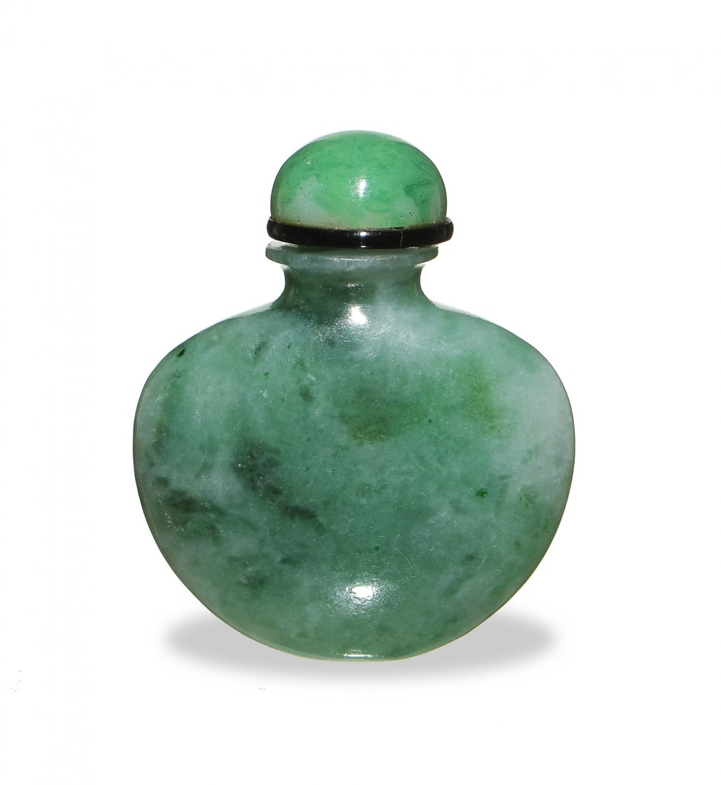 Chinese Jadeite Snuff Bottle, 19th Century: A Chinese jadeite snuff bottle dating from the 19th century. The snuff bottle has a glass stopper with no cork or spoon. Dimensions: 2 1/2 inches tall X 2 1/8 inches wide, 6.4 cm tall X 5.4 cm wide. A