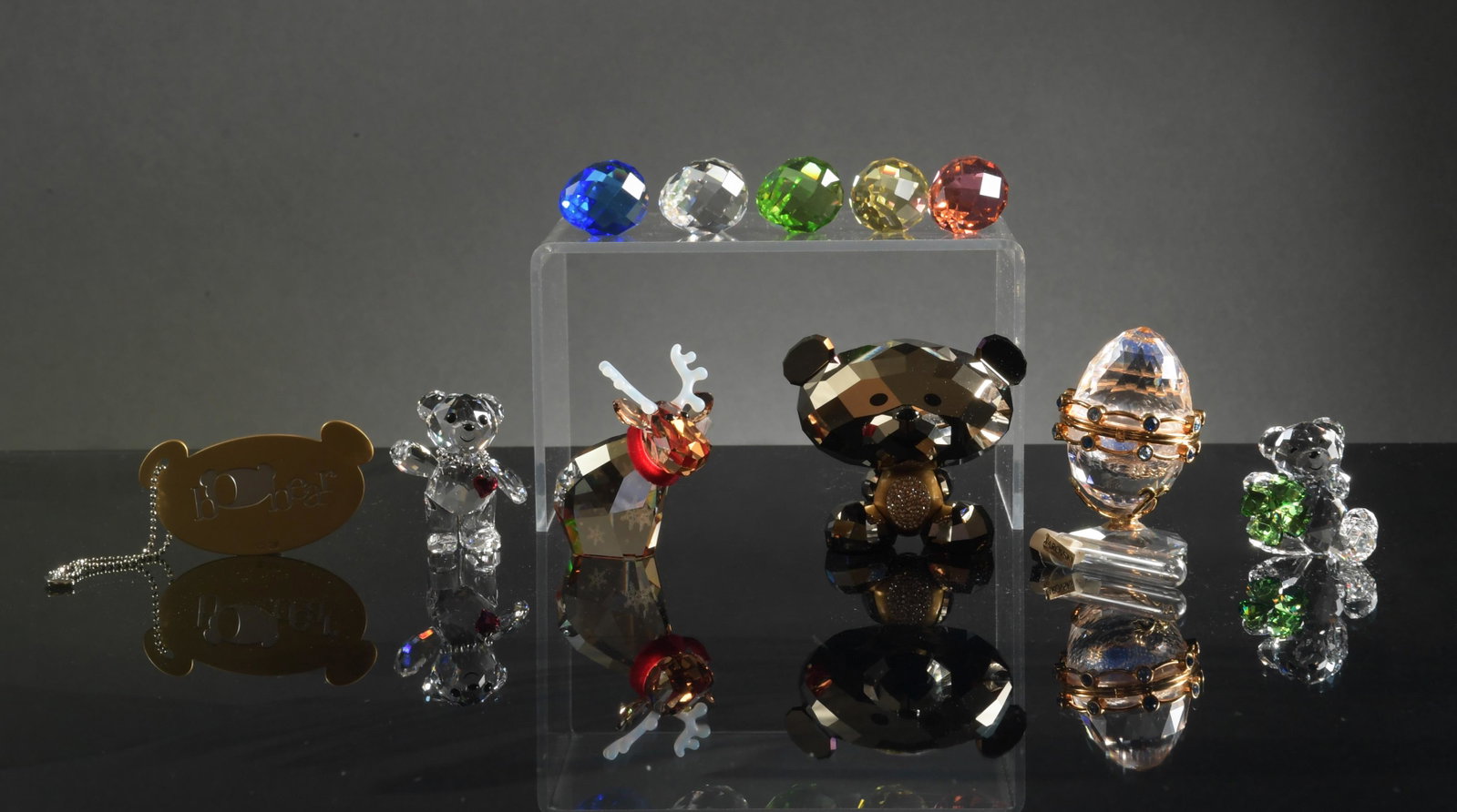 Swarovski, 6 Boxed Crystal Pieces: Swarovski (Austrian, founded 1895) crystal. A collection of SCS figurines including: egg filled with crystals; reindeer; eggs; a bear with shamrock; a bear with heart necklace; and Bo bear with a char