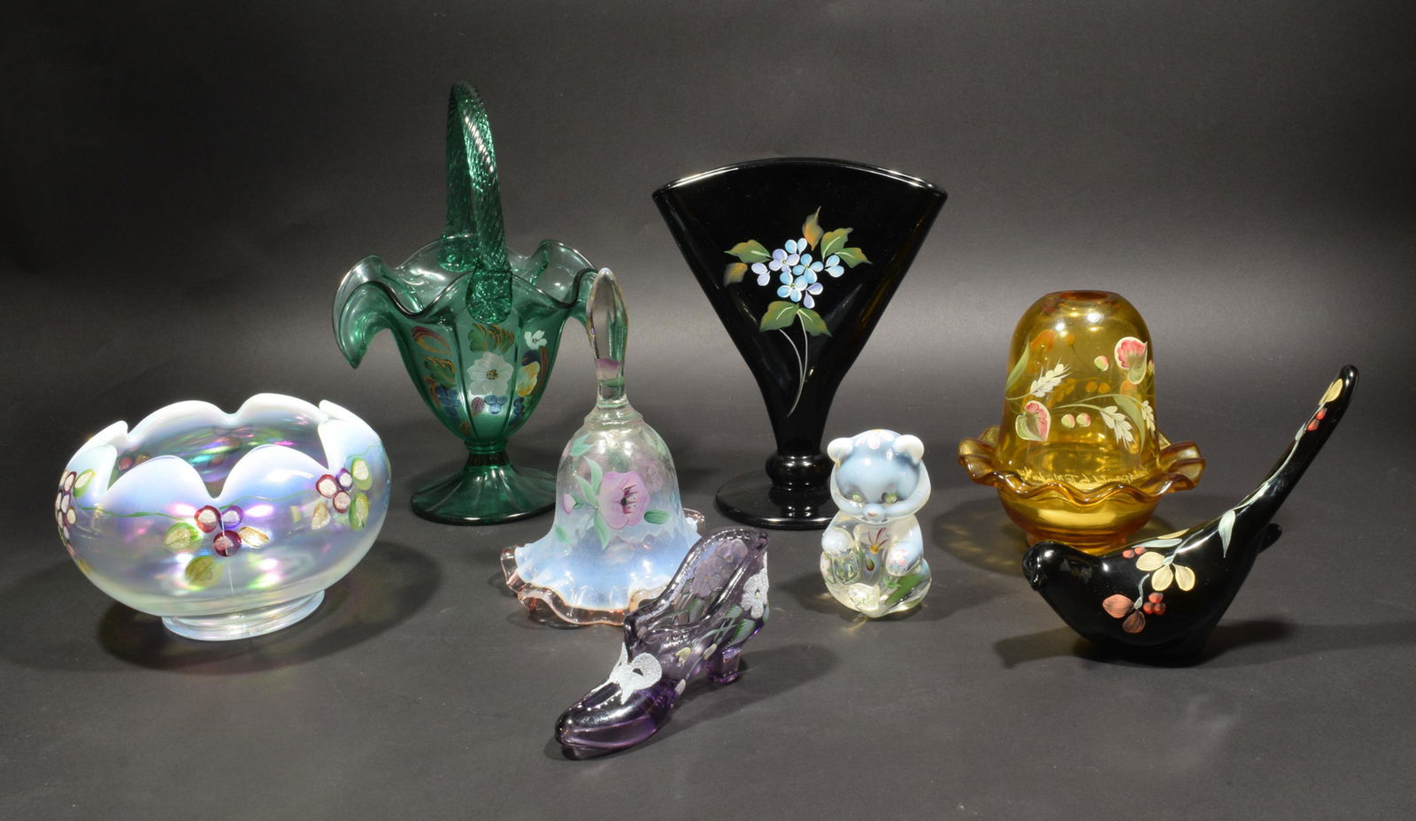 Fenton, 8 Boxed Signed and Hand Painted Glass Items: Fenton Art Glass (American, founded 1905) glass and paint. A group of 8 items, including a green basket with a handle; a black flattened vase; a yellow candle holder; a black bird; a bear; a purple sh