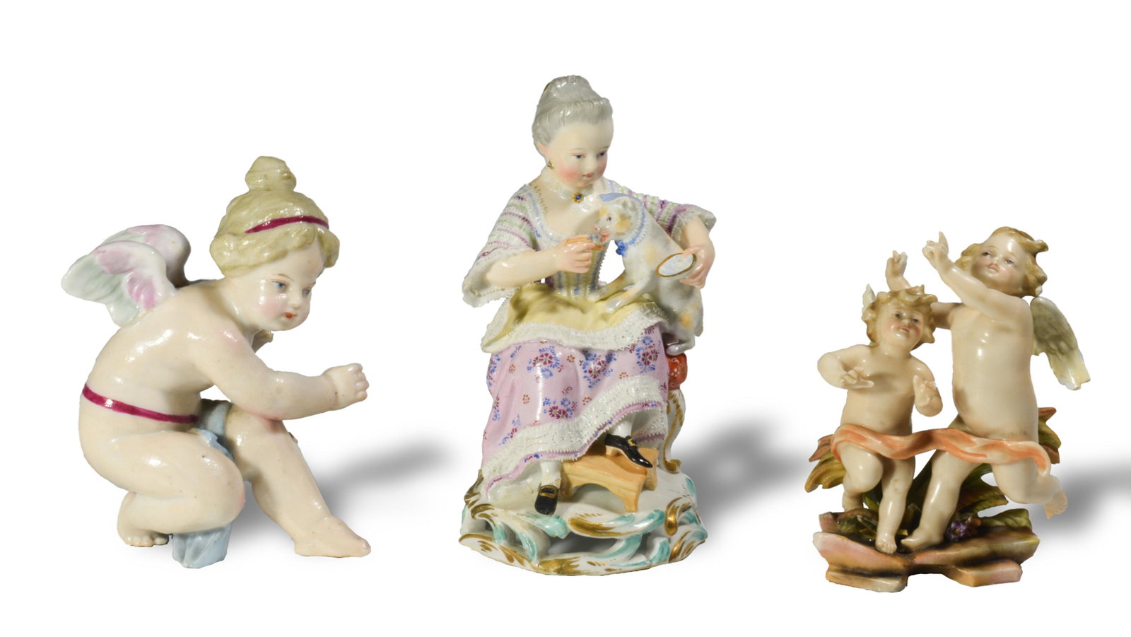 3 Porcelain Figures, Inc. Meissen Girl with Cat: A group of 3 porcelain items. Includes a Meissen (German, founded 1710) porcelain figure designed by Michel Victor Acier, depicting a girl feeding a cat, model B94. The cat is wearing a bonnet, and th