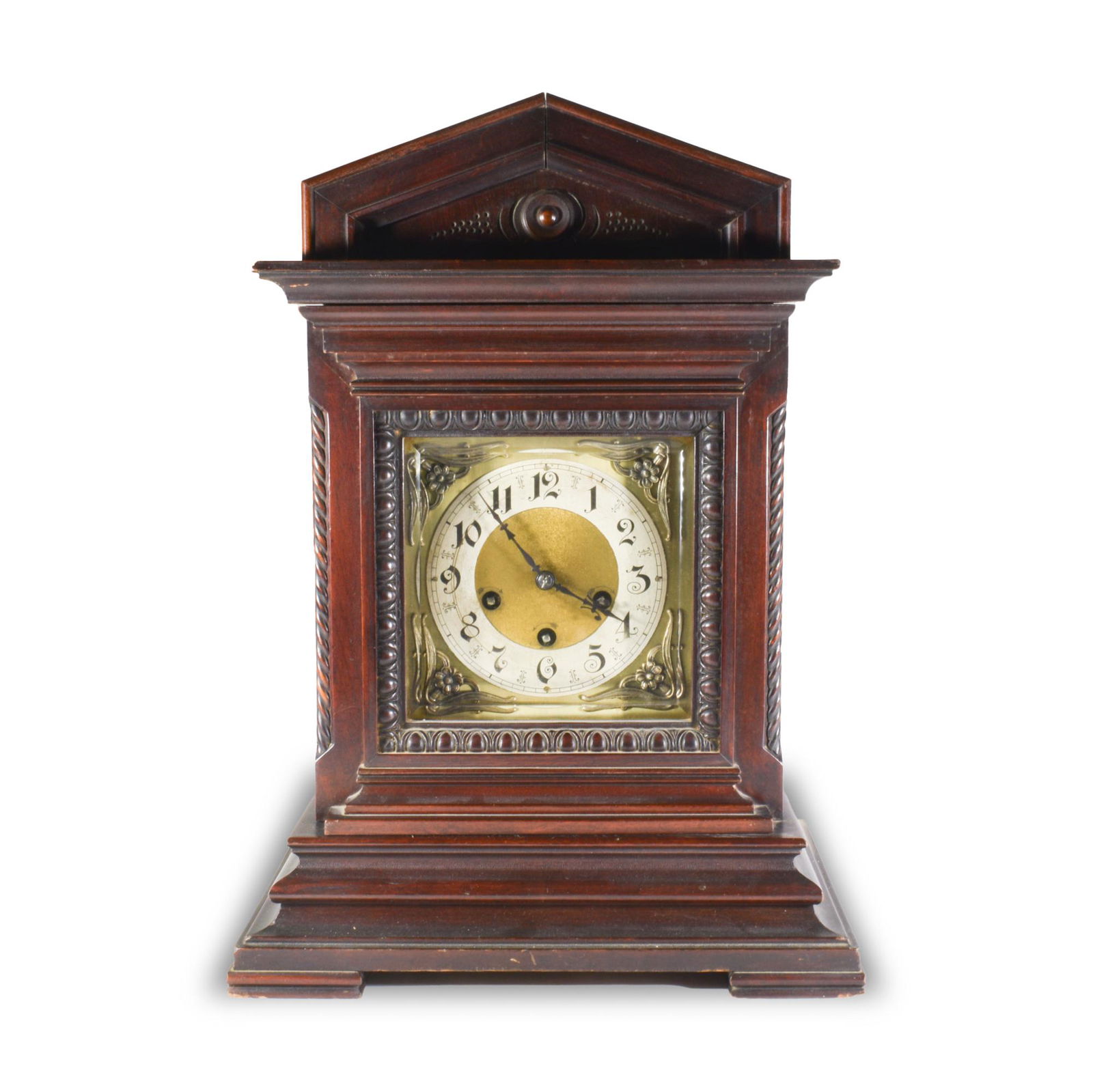 Junghans, 8 Day Mantel Clock Westminster Chime: Junghans (German, founded 1861) brass, walnut, circa 1900. The clock is in a mahogany housing with a brass face and mechanism. Surrounding the face are applique featuring leaves and flowers. The movem