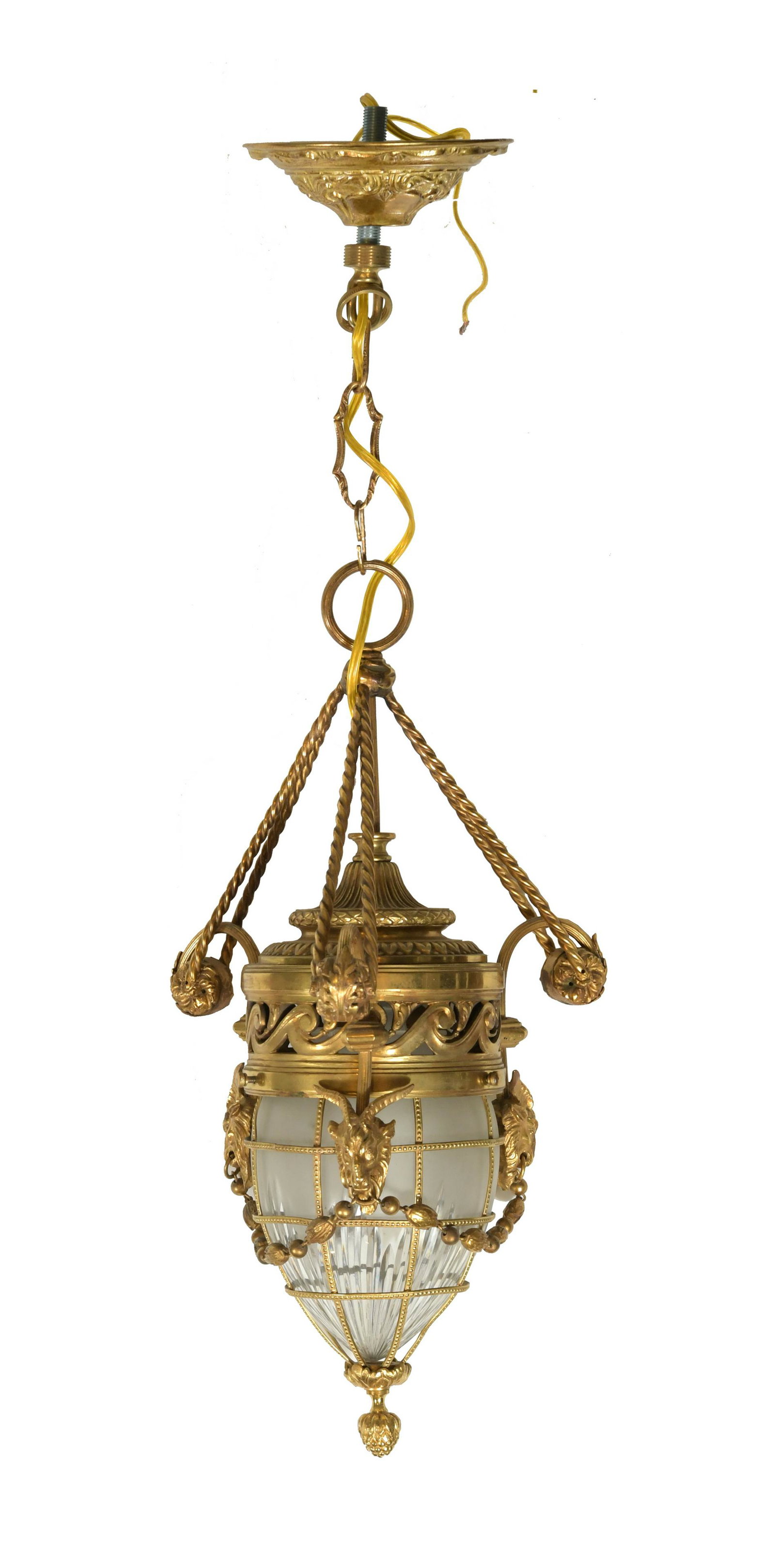 French Gilt Bronze Pendant Lamp: A gilt, French entry lamp with cut glass globe. Three arms and a central support carry the body of the lamp and are decorated with goat heads connected by a robust chain. Dimensions are: 28 inches tal