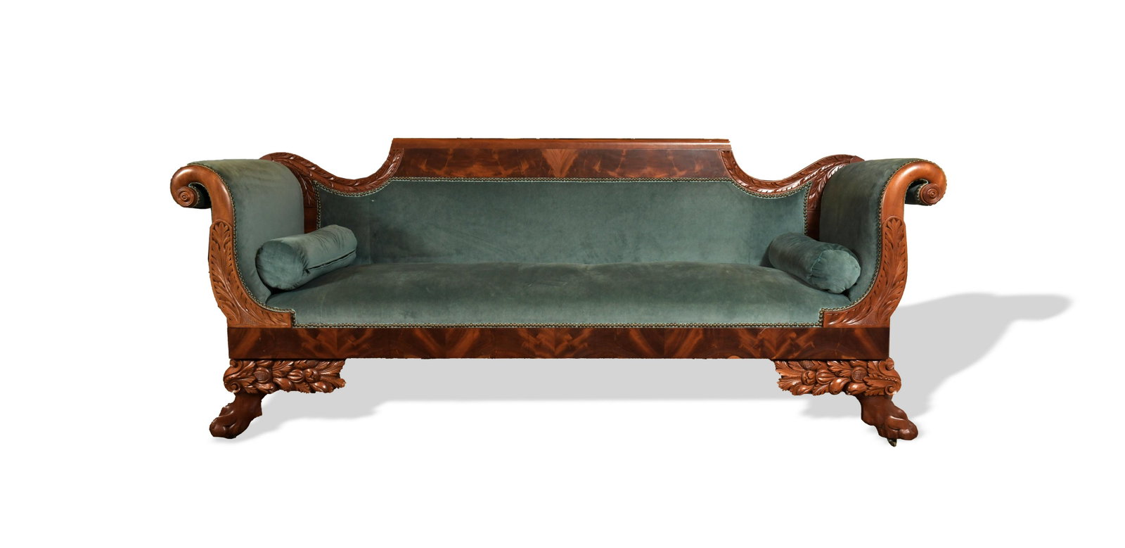 American Antique Carved Walnut Empire Sofa: An American Empire sofa from around 1835 with carved claw feet, acanthus leaf arm rests, and flame mahogany trim. Beautifully reupholstered with matching roll cushions. Dimensions are: 90 inches long 