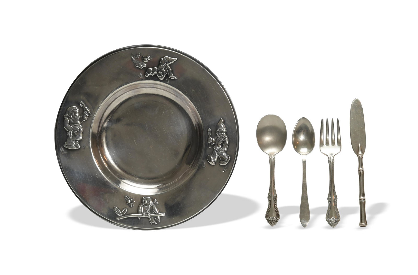 5 Sterling Child's Dish, Flatware, Inc. Tiffany: Tiffany & Co. Bamboo butter knife, Tiffany spoon. Oneida sterling Melbourne pattern spoon and fork, and an unmarked sterling child's dish with dwarves and a bird. Dimensions are: Dish, 7 3/16 inch dia