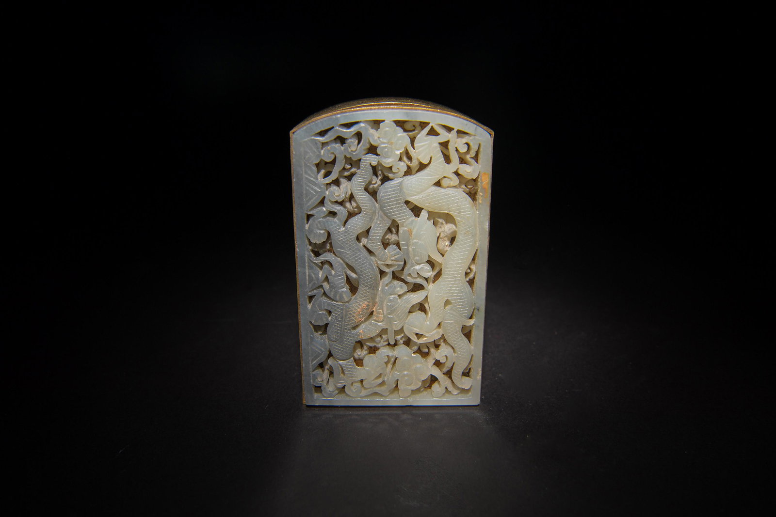 Chinese Black and White Jade Plaque with Box, Ming: A Chinese black and white pierced jade plaque dating from the Ming dynasty inset into a metal box. The plaques features a pair of dragons. Dimensions are: 2 3/8 inches tall X 3 3/4 inches wide, 6 cm X