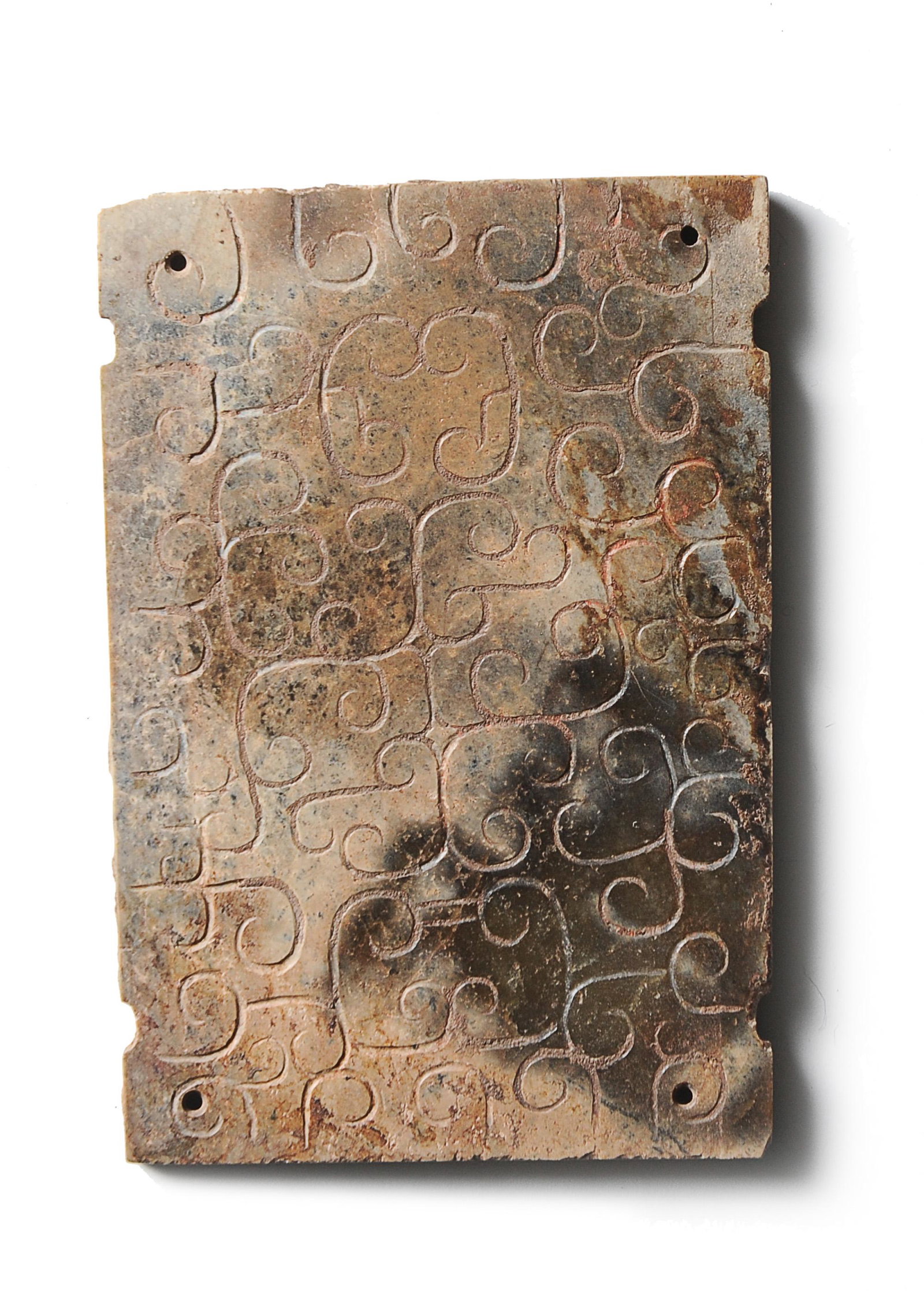 Rectangular Jade Plaque, Late Warring States: A Chinese jade plaque carved on 1 side with stylized ruyi interlace and dating from the late Warring States period. Dimensions are: 2 3/4 inches tall X 1 7/8 inches wide, 7 cm tall X 4.8 cm wide. All 