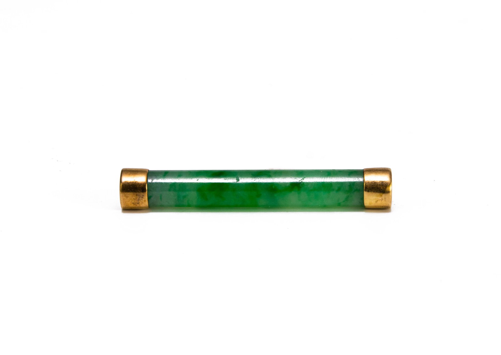 Chinese Jadeite Bar Brooch, Late 19th Century: A Chinese jadeite bar brooch dating to the late 19th century. Dimensions are: the pin measures 1 3/4 inches tall X 1/4 inches wide, 4.4 cm tall X .6 cm wide. All measurements are approximate.