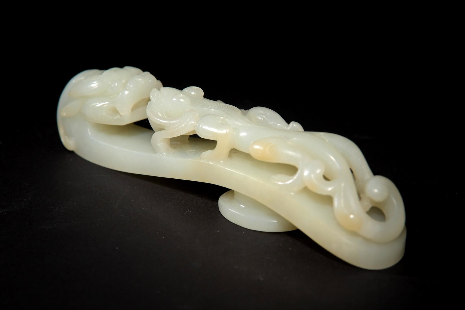 Chinese White Jade Dragon Hook, 18th Century or Earlier: A Chinese white jade dragon hook dating from the 18th century or earlier and featuring a Chilong with lingzhi. Dimensions are: 5 inches tall X 1 inches wide, 12.7 cm tall X 2.5 cm wide. All measuremen