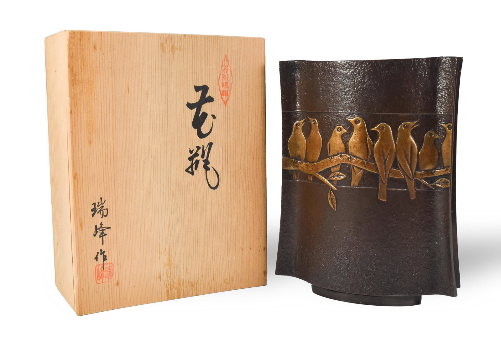 Japanese Mid-Century Bronze Vase with Birds: Comes in a wood box with two seals and calligraphy on the box lid. The square-shaped vase is signed on the bottom of the vase. Design is of birds lined up on a tree branch on both sides. Dimensions: 8