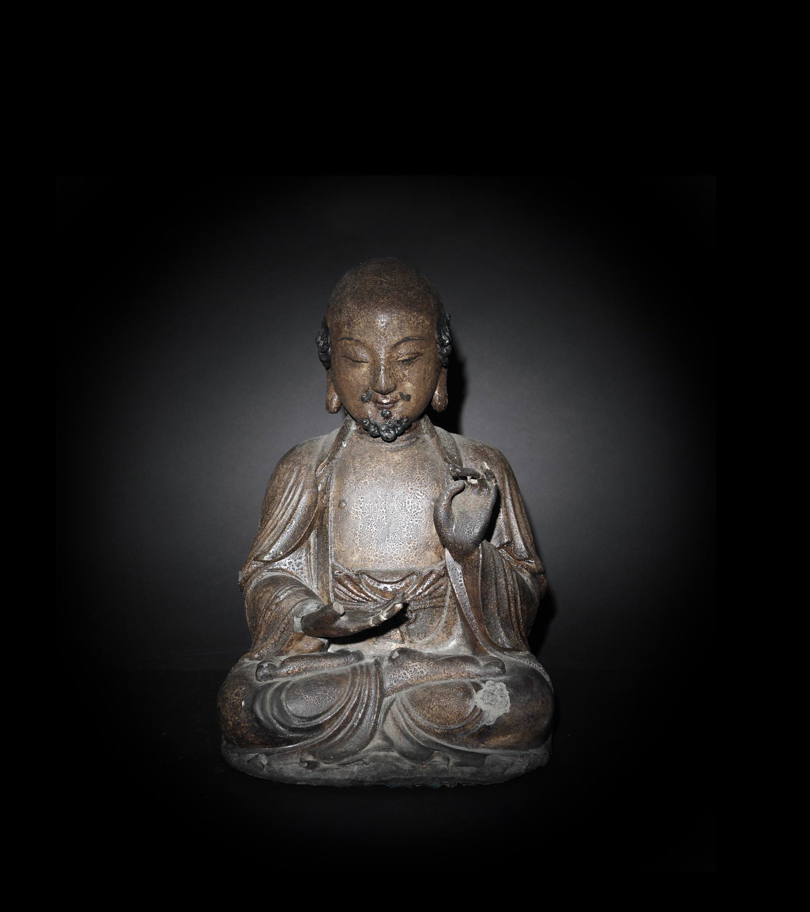 Chinese Gilt Wood Statue of a Monk, Ming Dynasty: A Chinese gilt wood statue of a Buddhist monk dating from the Ming dynasty. The monk has some hair and facial hair. The right hand is in dhyana mudra and the left is up in the abhaya mudra to allay fe