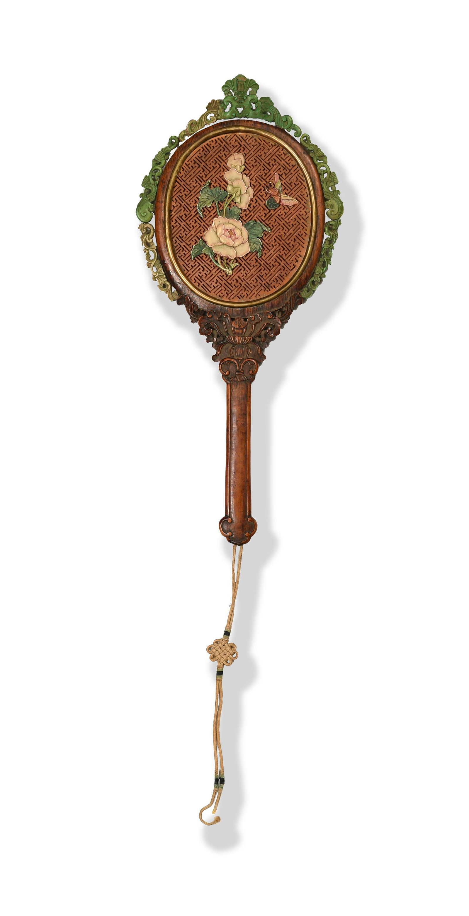 Chinese Tanxiang Wood Mirror, Qianlong Period: A Chinese tanxiang wood hand mirror dating from the Qianlong period. The back of the mirror is carved with flowers and a butterfly on a geometric ground. Carved green leaf tracery frames the mirror it