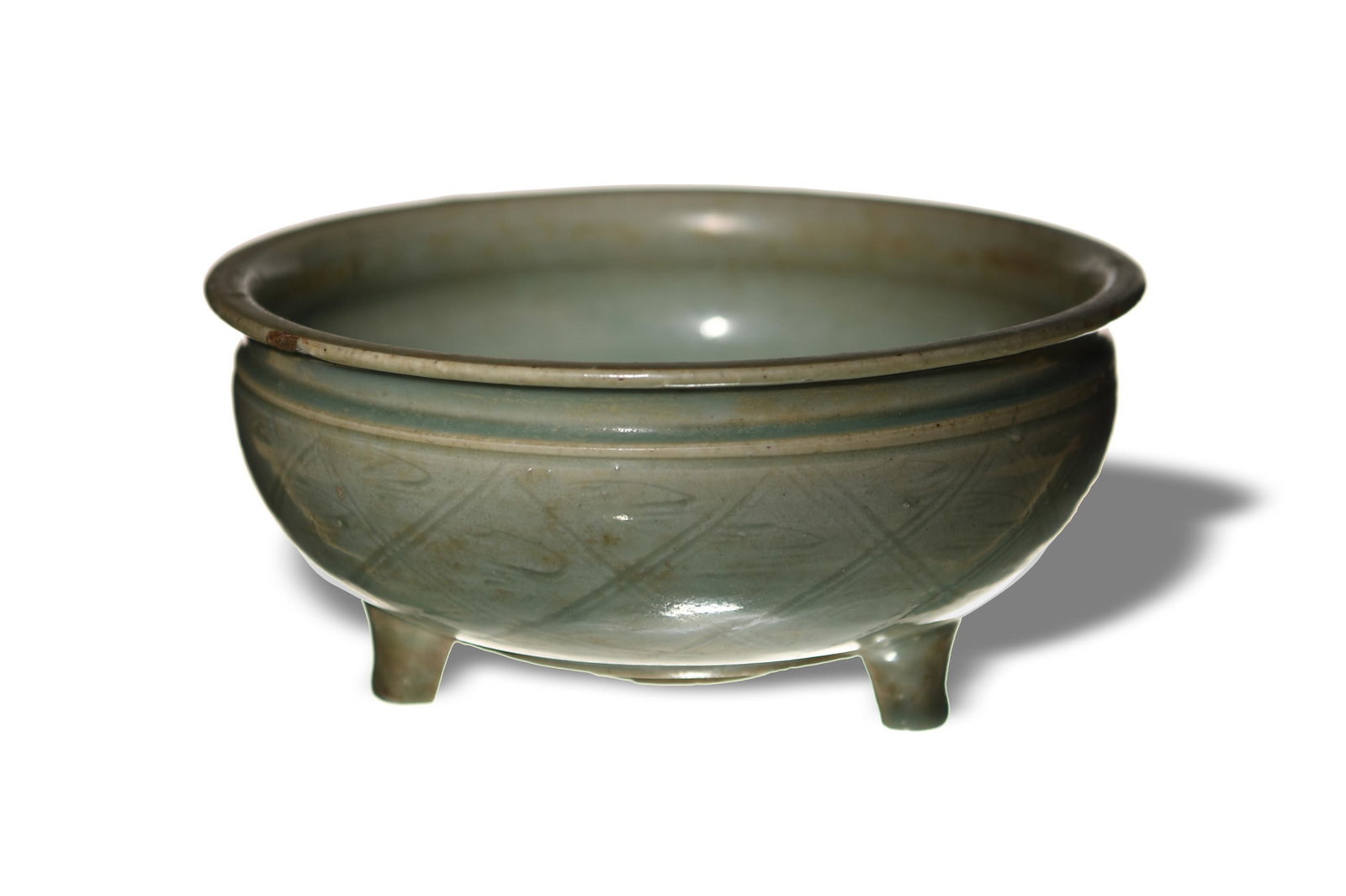 Chinese Celadon Longquan Tripod Censer, Yuan or Ming: A Chinese celadon Longquan ceramic censer dating from the Yuan or Ming dynasty. The exterior of the tripod censer is incised with a crosshatch design. Dimensions are: 3 3/4 inches tall X 8 1/4 inches 