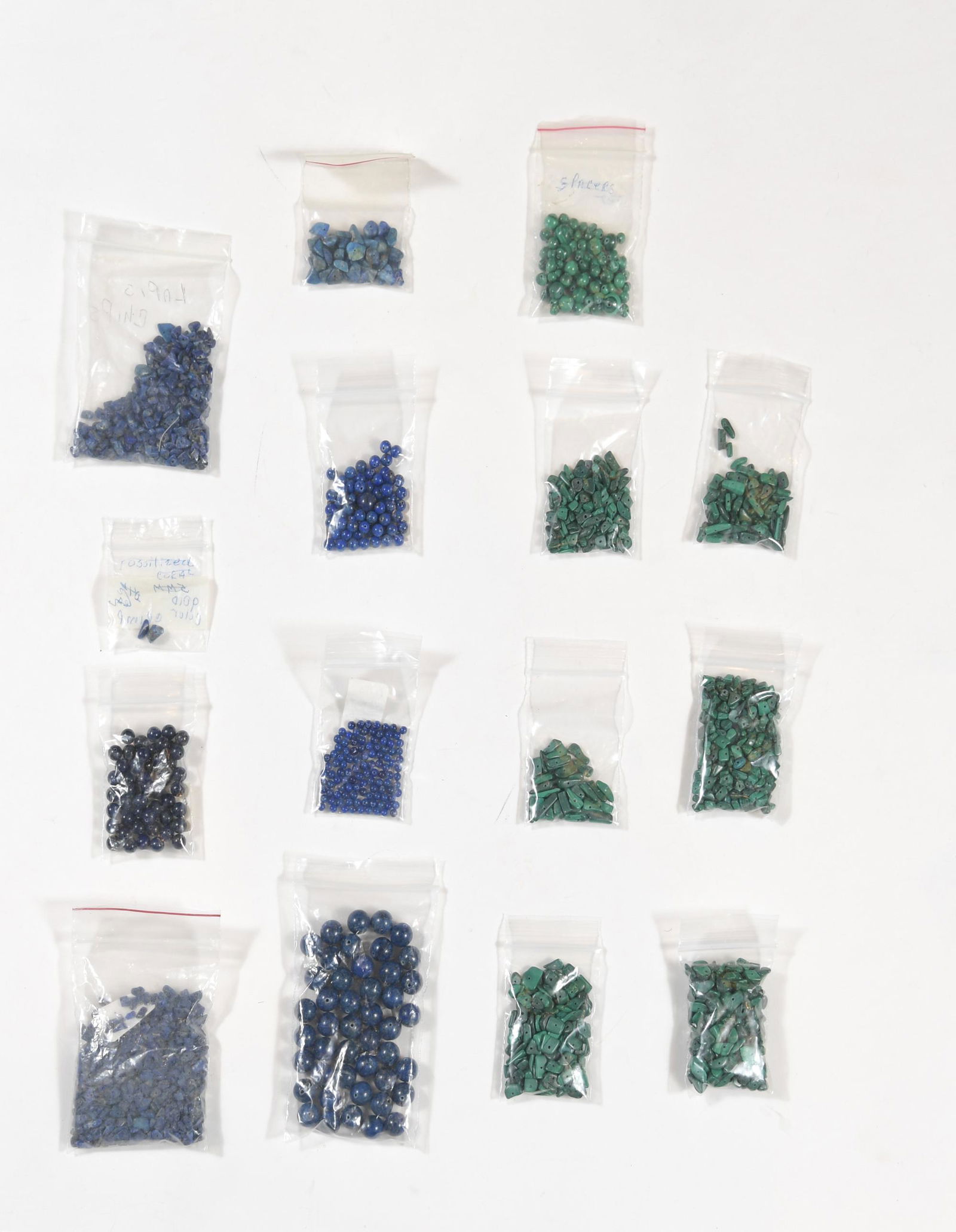 Lot of Loose Lapis Lazuli and Malachite Beads: Seven packets of malachite beads in round and organic shapes. Eight packets of lapis lazuli beads with four packets of ranging sizes of round beads and three packets of organic shaped beads. Weight: 6