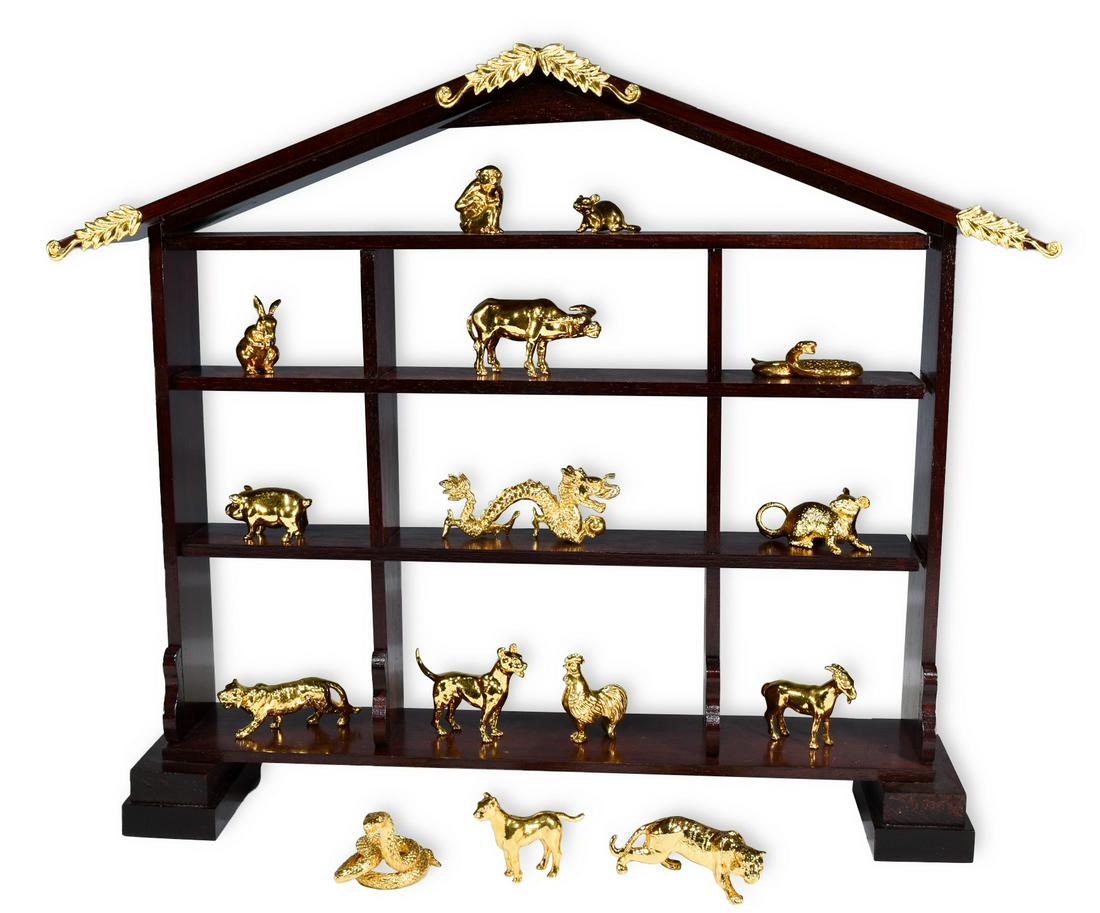 15, 24K Gold Plated Chinese Zodiac Figures: Made in Singapore by Risis. In a wood display with gold plated accents, includes several boxes. Missing horse figurine to complete the set. Duplicates included are the dog, tiger, snake and rat. Dimen