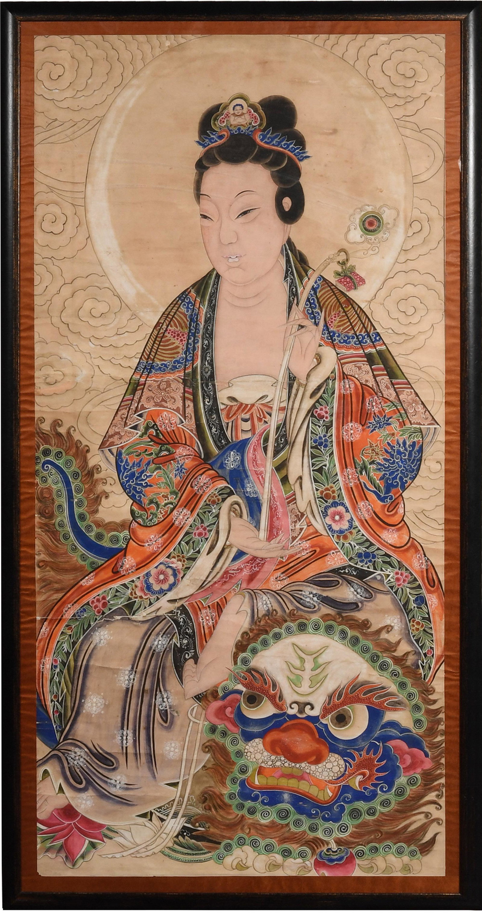Chinese Painting of Guanyin, 19th Century: A Chinese watercolor and ink painting on paper of Guanyin dating from the 19th century. She is riding a guardian lion and holding a ruyi wand. The painting is mounted on a silk backing and framed. Dim