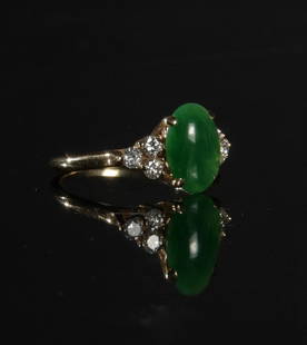 14K Gold Jadeite and Diamond Ring: A 14K yellow gold ring with a cabochon jadeite stone surrounded by 6 full cut diamonds totaling approximately .30 ctw. Dimensions are: Total Weight: 3.1 grams (.10 ozt). Ring size: 6. All