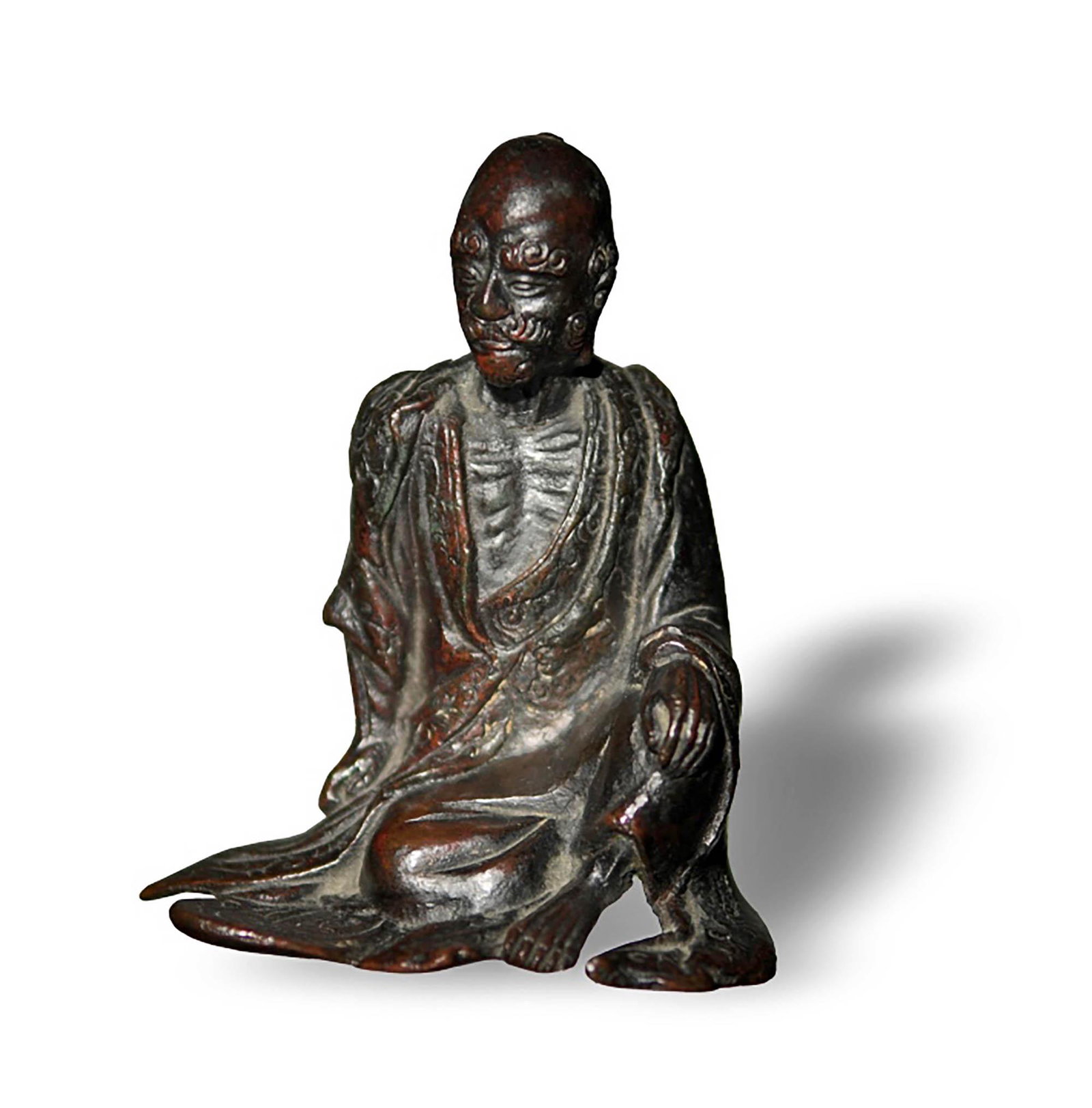 Japanese Bronze Buddhist Figure: A Japanese bronze Buddhist figure dating to the Meiji period. The figure is of an old man seated with his ribs showing out from his ropes. Dimensions are: 4 1/2 inches tall X 4 inches wide, 11.43 cm X
