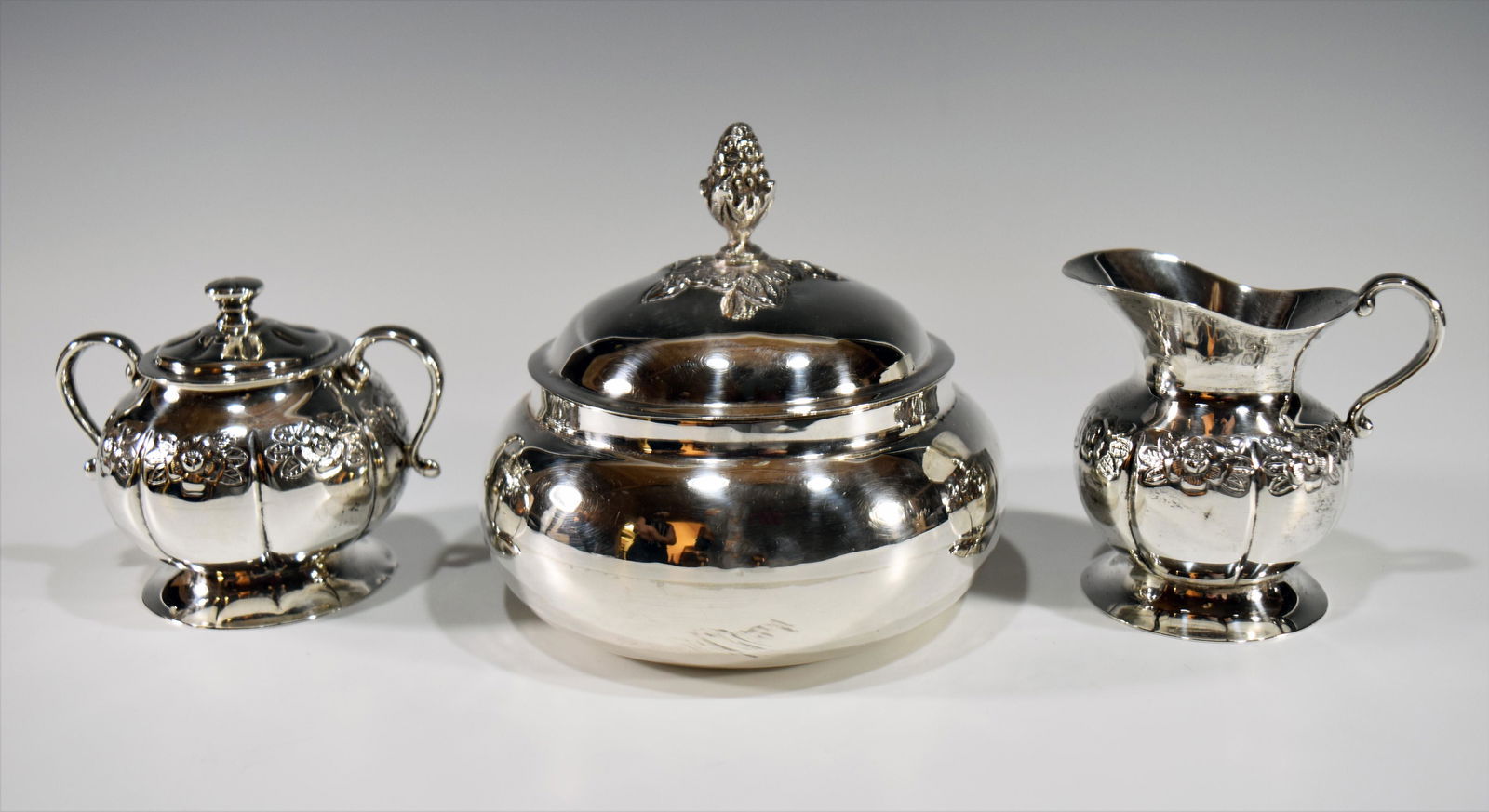 3 Sanborns Sterling Creamer and Sugar, Cover Bowl: This lot includes a covered bowl by Salvador de la Serna and a small creamer and a lidded sugar bowl by Sanborns. All pieces are from Mexico City and feature floral designs. Dimensions are: 4 3/4 inch