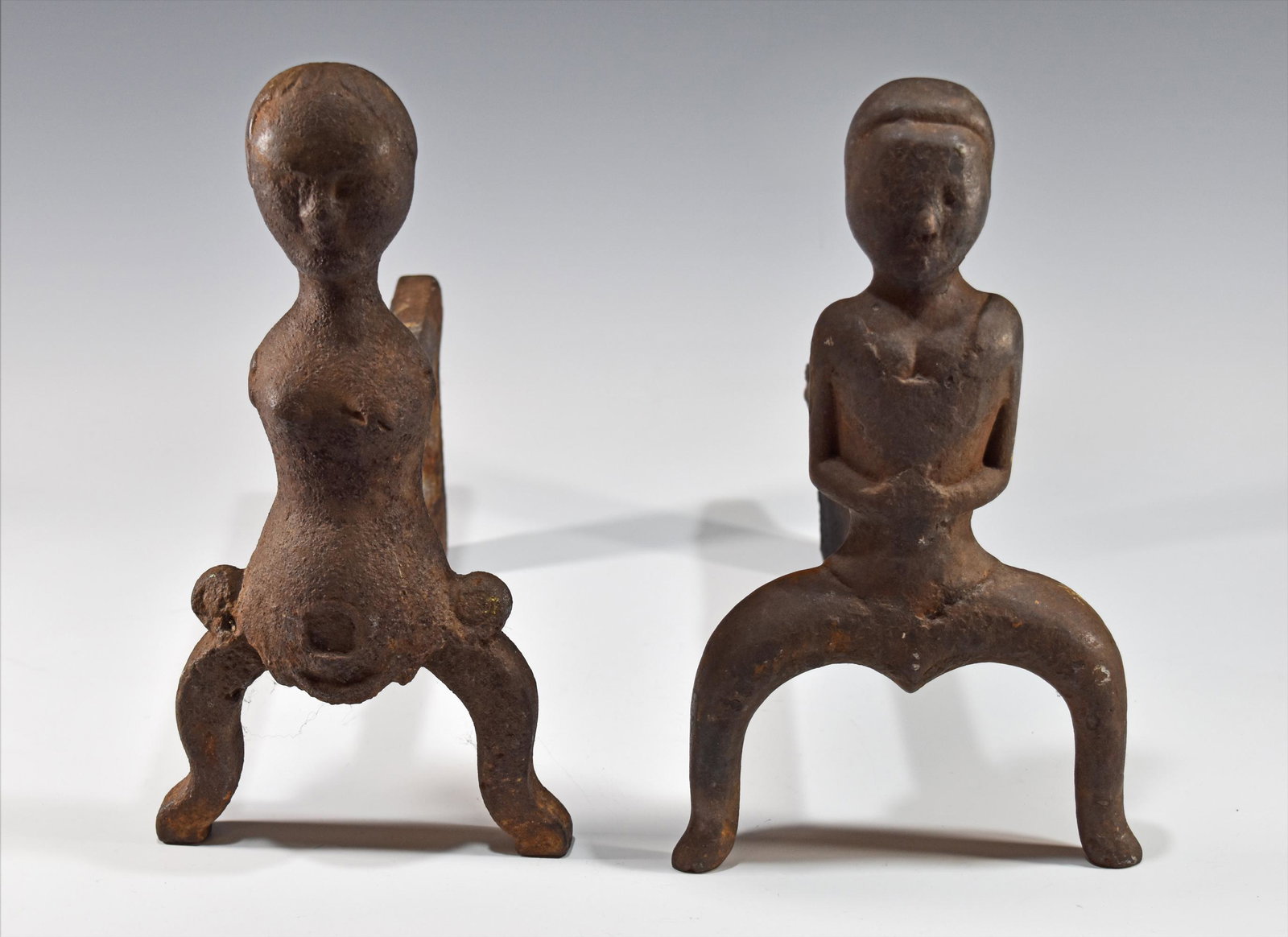 American Cast Iron Figural Andirons, 19th Century: A 19th century American cast iron figural andirons of a man and a woman. Dimensions are: 12 1/2 inches tall X 12 inches wide, 31.75 cm X 30.48 cm. All measurements are approximate. Condition: Heavy us
