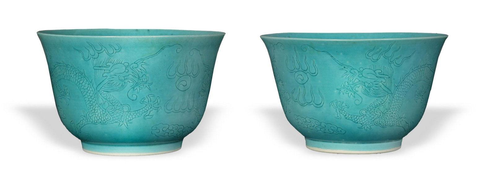 Pair of Peacock Blue Bowls, 18/19th Century: A pair of peacock blue bowls dating from the 18th to the 19th century. The bowls are incised with a pair of dragons chasing a flaming pearl. Dimensions are: 3 3/4 inches tall X 6 inches wide, 9.53 cm 