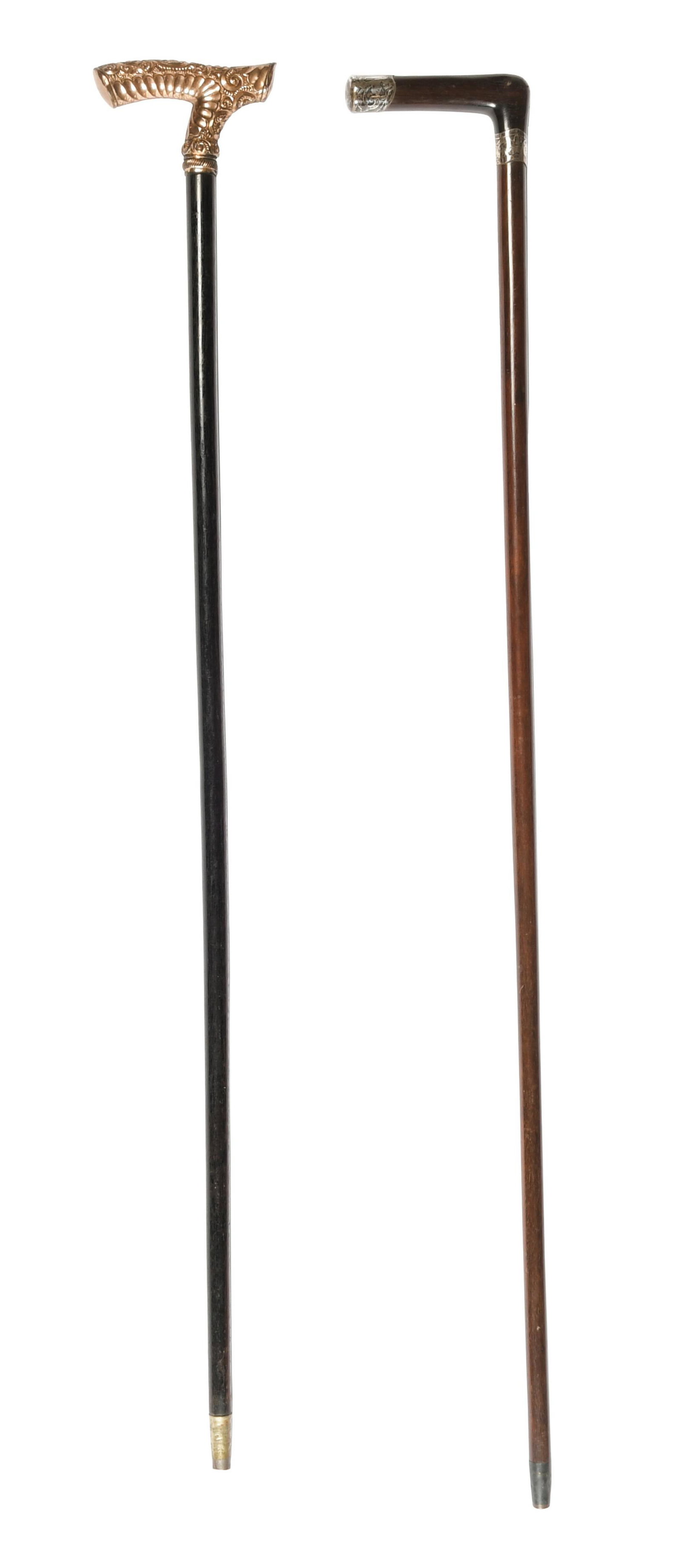 2 Presentation Canes, Sterling and Gold Rolled: A group of two presentation canes including one with a scroll and foliate decorated gold rolled head inscribed 'Geo. H. Carr, from P. R. Boys.' 'The Leader', is on an ebonised wood stick with the orig