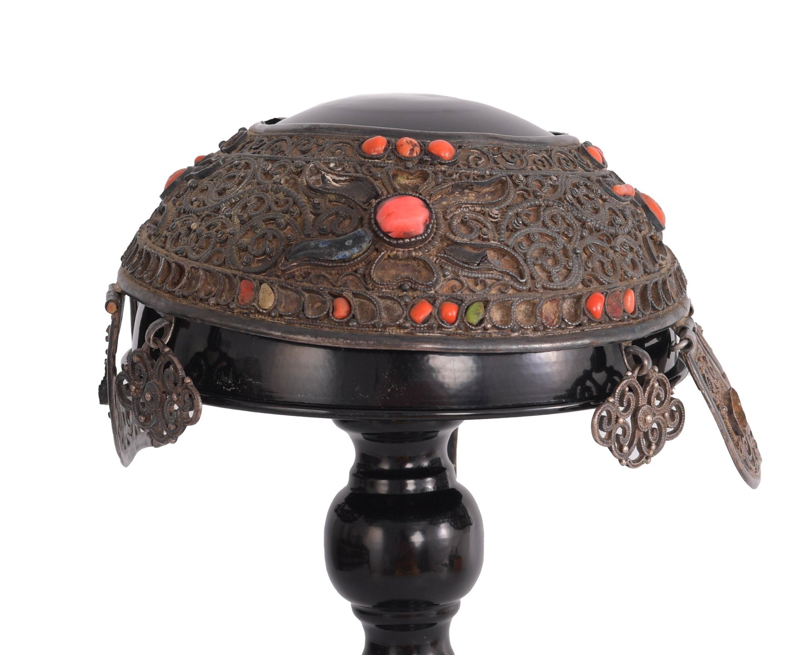 Mongolian Silver, Coral Wedding Cap: A Mongolian Khalkha silver wedding cap with inlaid precious stones including coral. The cap features scrollwork with decorative coral flower motifs to the front, back, and sides, framed on the top and